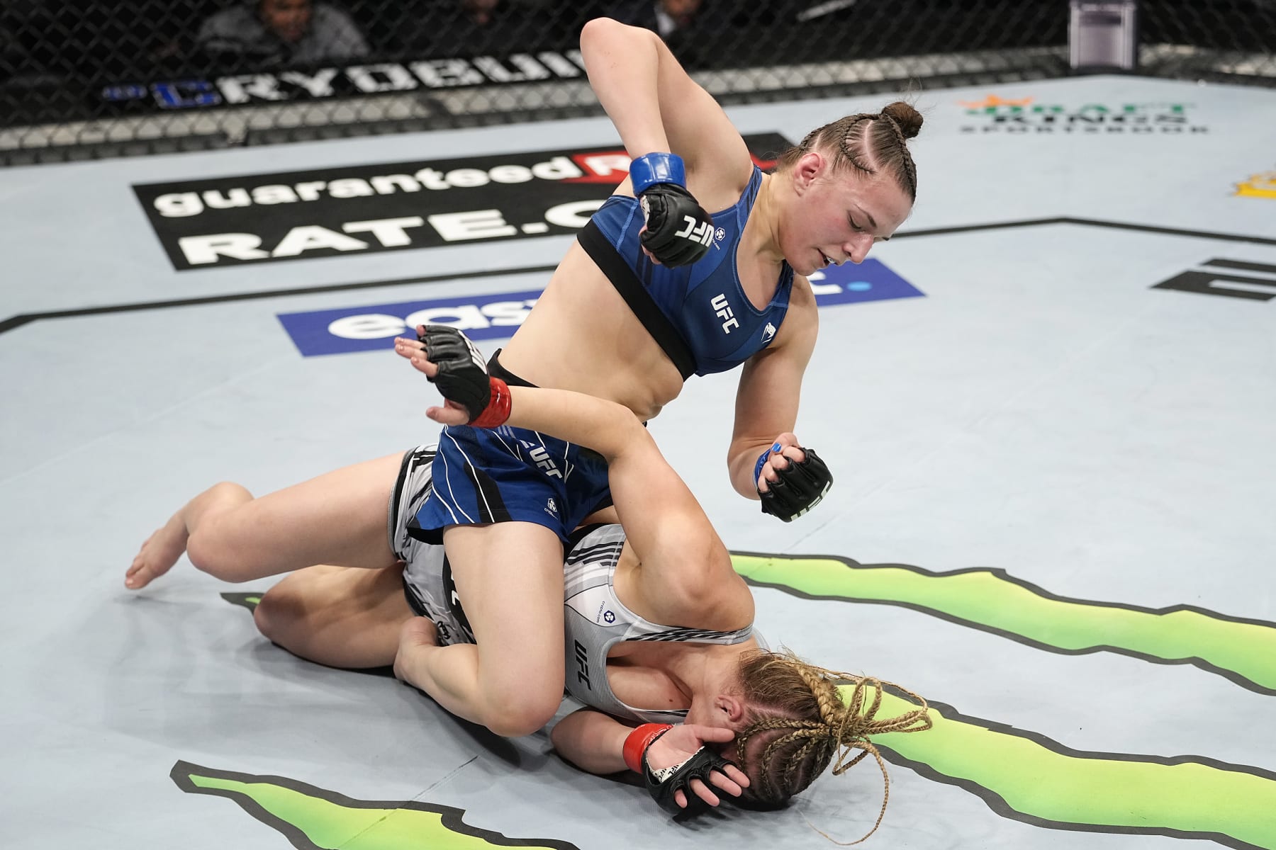 LAS VEGAS, NEVADA - DECEMBER 11: Erin Blanchfield (blue shorts) punches Miranda Maverick (grey shorts) in their flyweight bout during the UFC 269 on December 11, 2021 in Las Vegas, Nevada. (Photo by Jeff Bottari/Zuffa LLC)