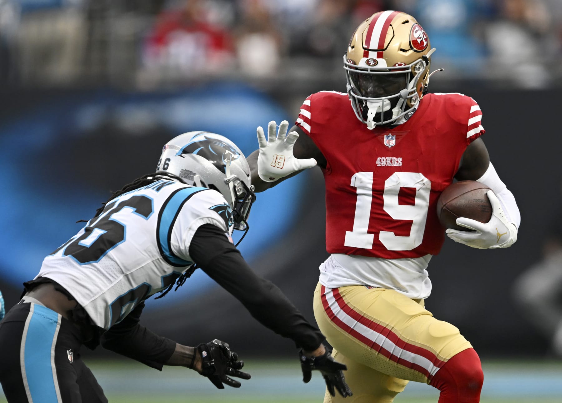 CHARLOTTE, NORTH CAROLINA - OCTOBER 09: Deebo Samuel #19 of the San Francisco 49ers gets tackled by Donte Jackson #26 of the Carolina Panthers in the third quarter at Bank of America Stadium on October 09, 2022 in Charlotte, North Carolina. (Photo by Eakin Howard/Getty Images)