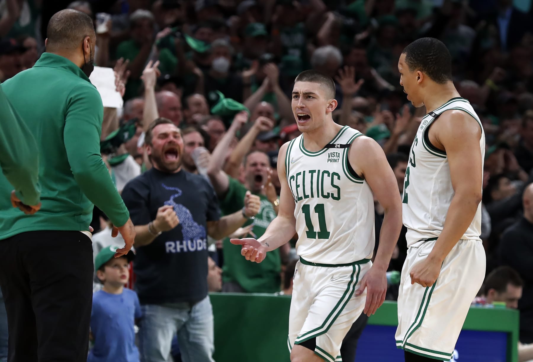 Boston - May 15: Left to right, Celtics head coach Ime Udoka, the fans, Payton Pritchard and Grant Williams celebrate one of Pritchard's three pointers. The Boston Celtics host the Milwaukee Bucks in Game 7 of the Eastern Conference semi-finals between the Celtics and Bucks on May 15, 2022 at TD Garden in Boston. (Photo by Jim Davis/The Boston Globe via Getty Images)