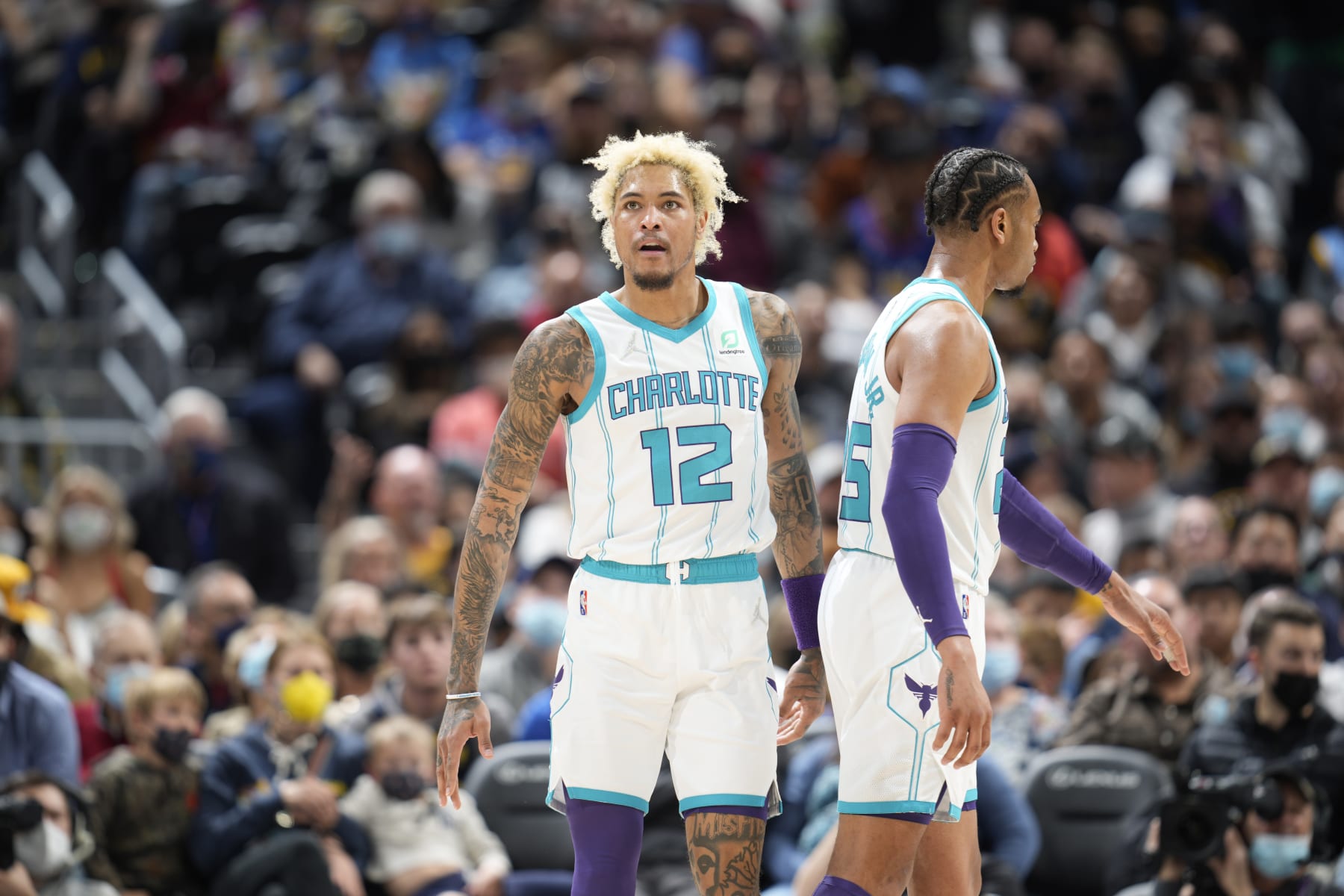 Charlotte Hornets guard Kelly Oubre Jr. (12) and Charlotte Hornets forward P.J. Washington (25) in the second half of an NBA basketball game Thursday, Dec. 23, 2021, in Denver. The Hornets won 115-107. (AP Photo/David Zalubowski)