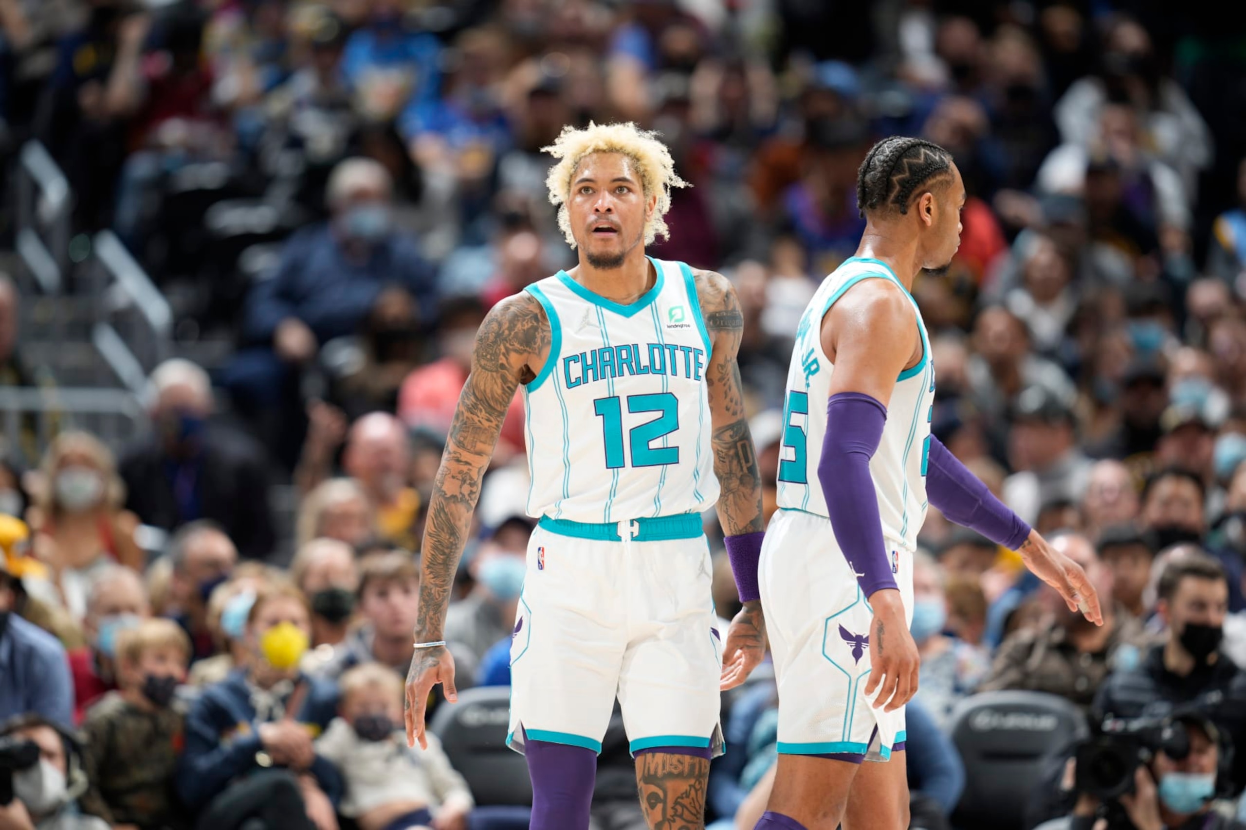 Charlotte Hornets guard Kelly Oubre Jr. (12) and Charlotte Hornets forward P.J. Washington (25) in the second half of an NBA basketball game Thursday, Dec. 23, 2021, in Denver. The Hornets won 115-107. (AP Photo/David Zalubowski)