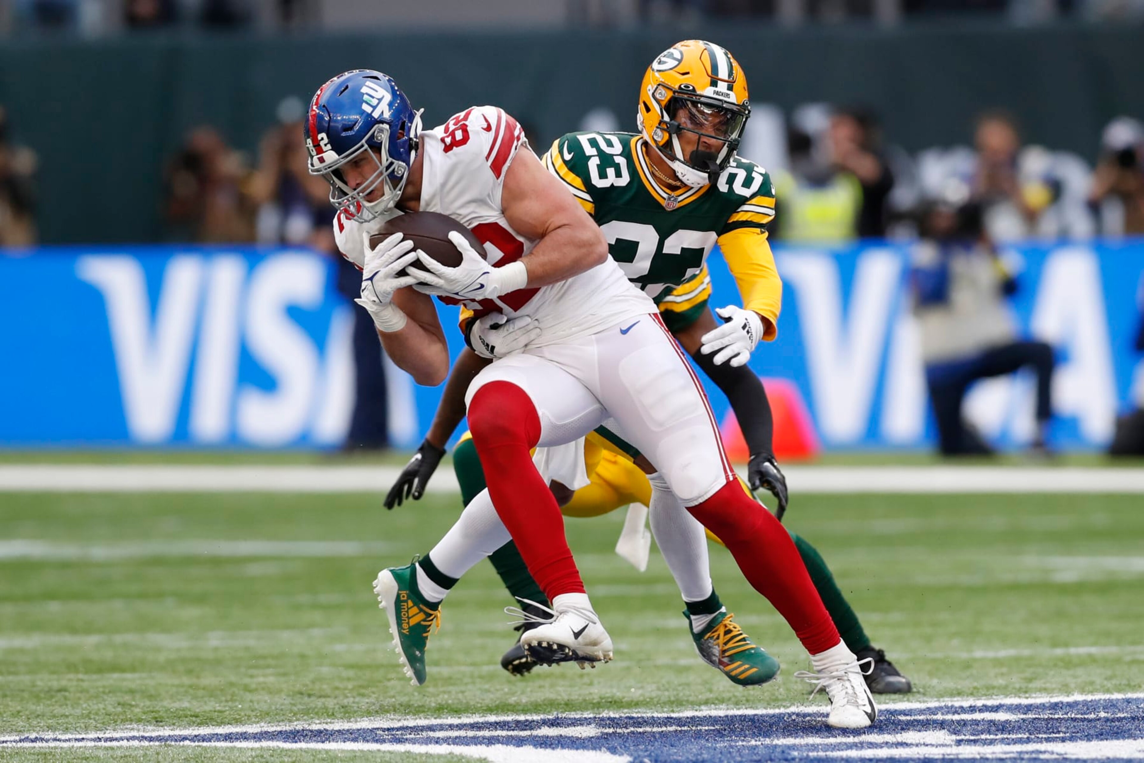 Green Bay Packers cornerback Jaire Alexander (23) tackles New York Giants tight end Daniel Bellinger (82) during an NFL football game at Tottenham Hotspur Stadium in London, Sunday, Oct. 9, 2022. The New York Giants won 27-22. (AP Photo/Steve Luciano) Green Bay Packers cornerback Jaire Alexander (23) tackles New York Giants tight end Daniel Bellinger (82) during an NFL football game at Tottenham Hotspur Stadium in London, Sunday, Oct. 9, 2022. The New York Giants won 27-22. (AP Photo/Steve Luciano)