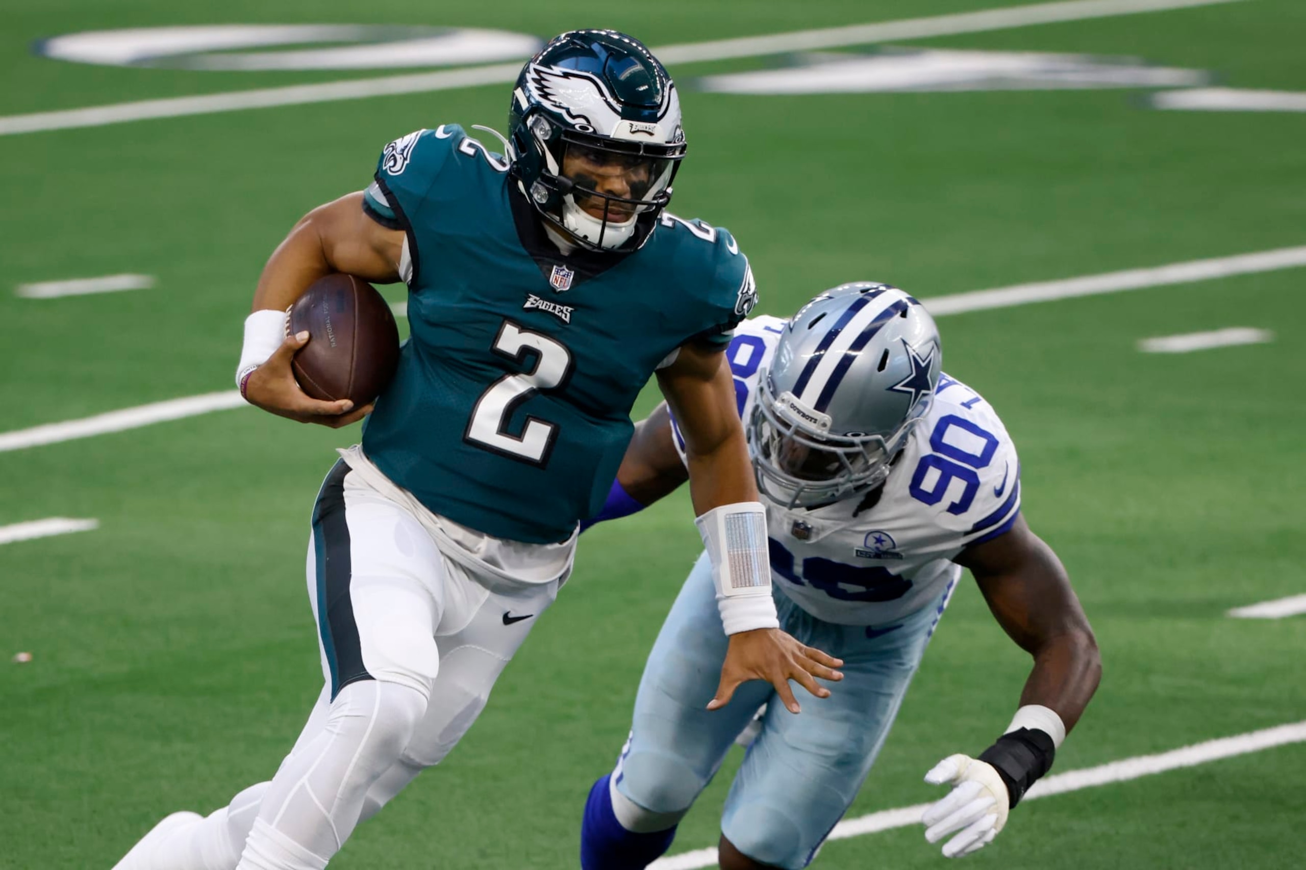 Philadelphia Eagles quarterback Jalen Hurts (2) escapes pressure from Dallas Cowboys defensive end DeMarcus Lawrence (90) in the first half of an NFL football game in Arlington, Texas, Sunday, Dec. 27. 2020. (AP Photo/Ron Jenkins) Philadelphia Eagles quarterback Jalen Hurts (2) escapes pressure from Dallas Cowboys defensive end DeMarcus Lawrence (90) in the first half of an NFL football game in Arlington, Texas, Sunday, Dec. 27. 2020. (AP Photo/Ron Jenkins)