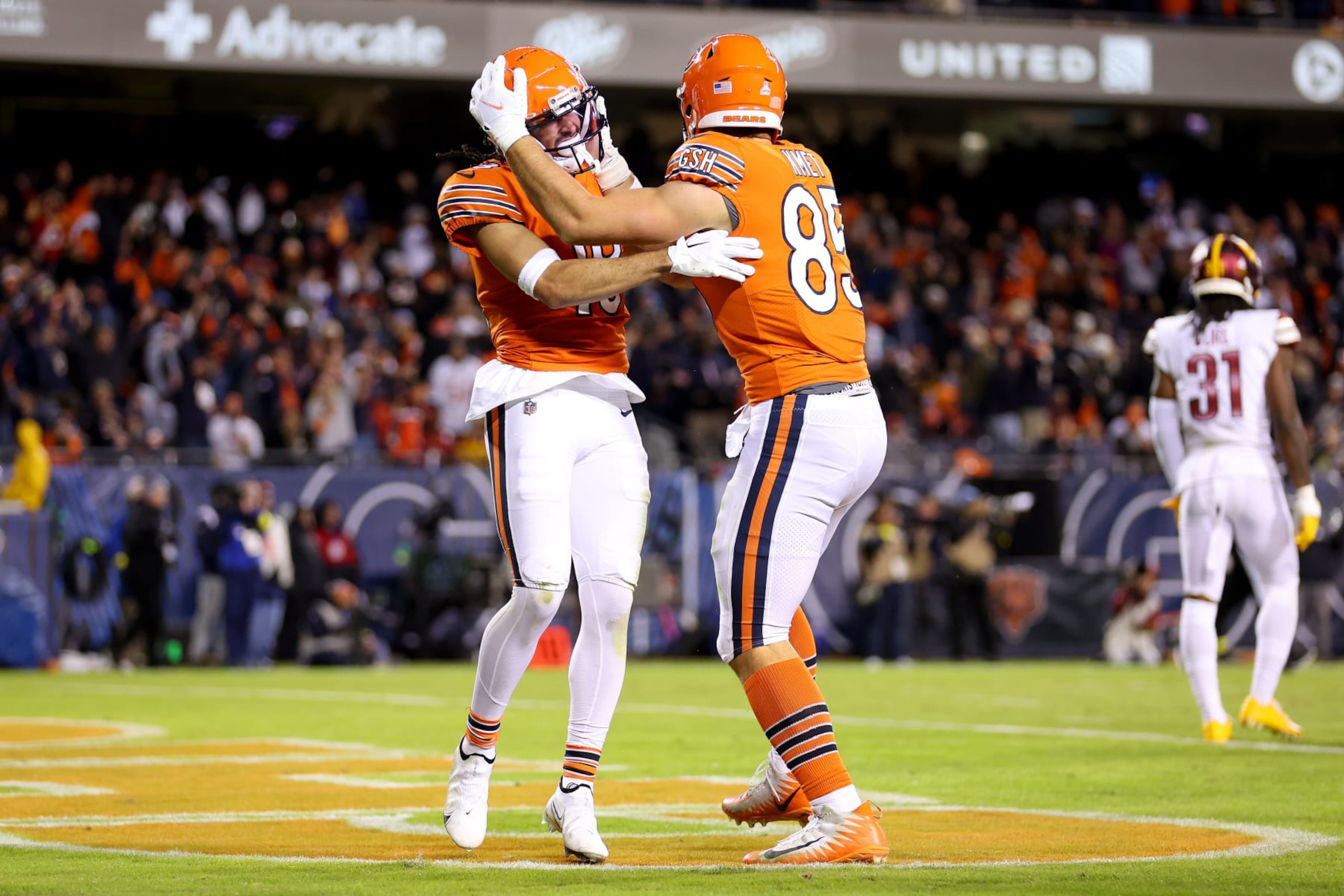CHICAGO, ILLINOIS - OCTOBER 13: Dante Pettis #18 and Cole Kmet #85 of the Chicago Bears celebrate a touchdown against the Washington Commanders during the third quarter at Soldier Field on October 13, 2022 in Chicago, Illinois. (Photo by Michael Reaves/Getty Images)