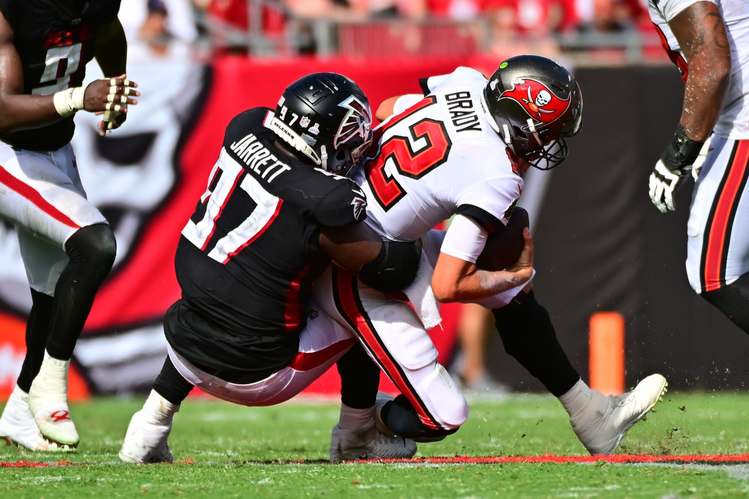 TAMPA, FLORIDA - OCTOBER 09: Grady Jarrett #97 of the Atlanta Falcons sacks Tom Brady #12 of the Tampa Bay Buccaneers during the fourth quarter of the game at Raymond James Stadium on October 09, 2022 in Tampa, Florida. (Photo by Julio Aguilar/Getty Images)
