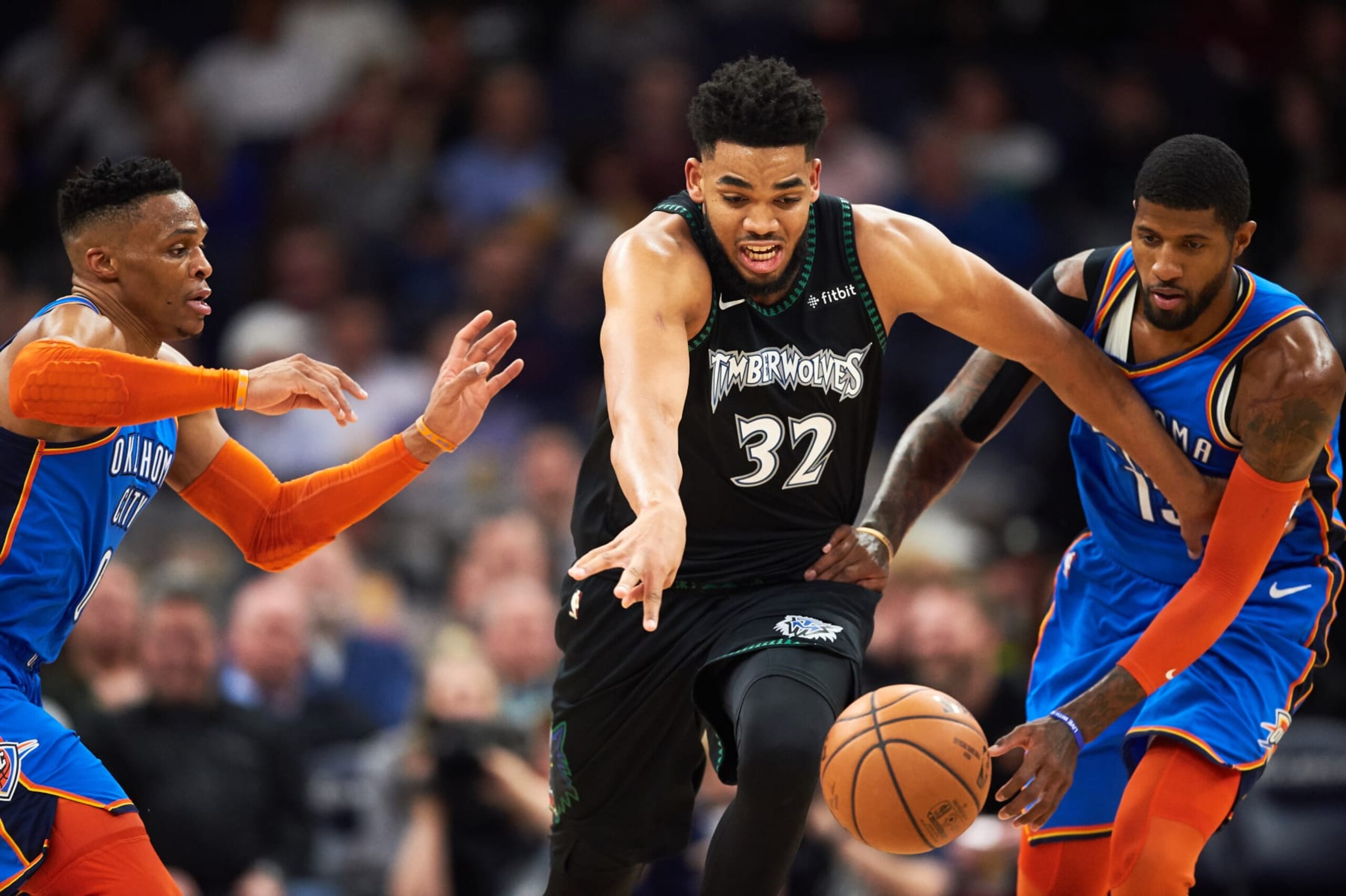 MINNEAPOLIS, MN - MARCH 05: Karl-Anthony Towns #32 of the Minnesota Timberwolves dribbles the ball against Russell Westbrook #0 and Paul George #13 of the Oklahoma City Thunder during the game on March 5, 2019 at the Target Center in Minneapolis, Minnesota. NOTE TO USER: User expressly acknowledges and agrees that, by downloading and or using this Photograph, user is consenting to the terms and conditions of the Getty Images License Agreement. (Photo by Hannah Foslien/Getty Images)