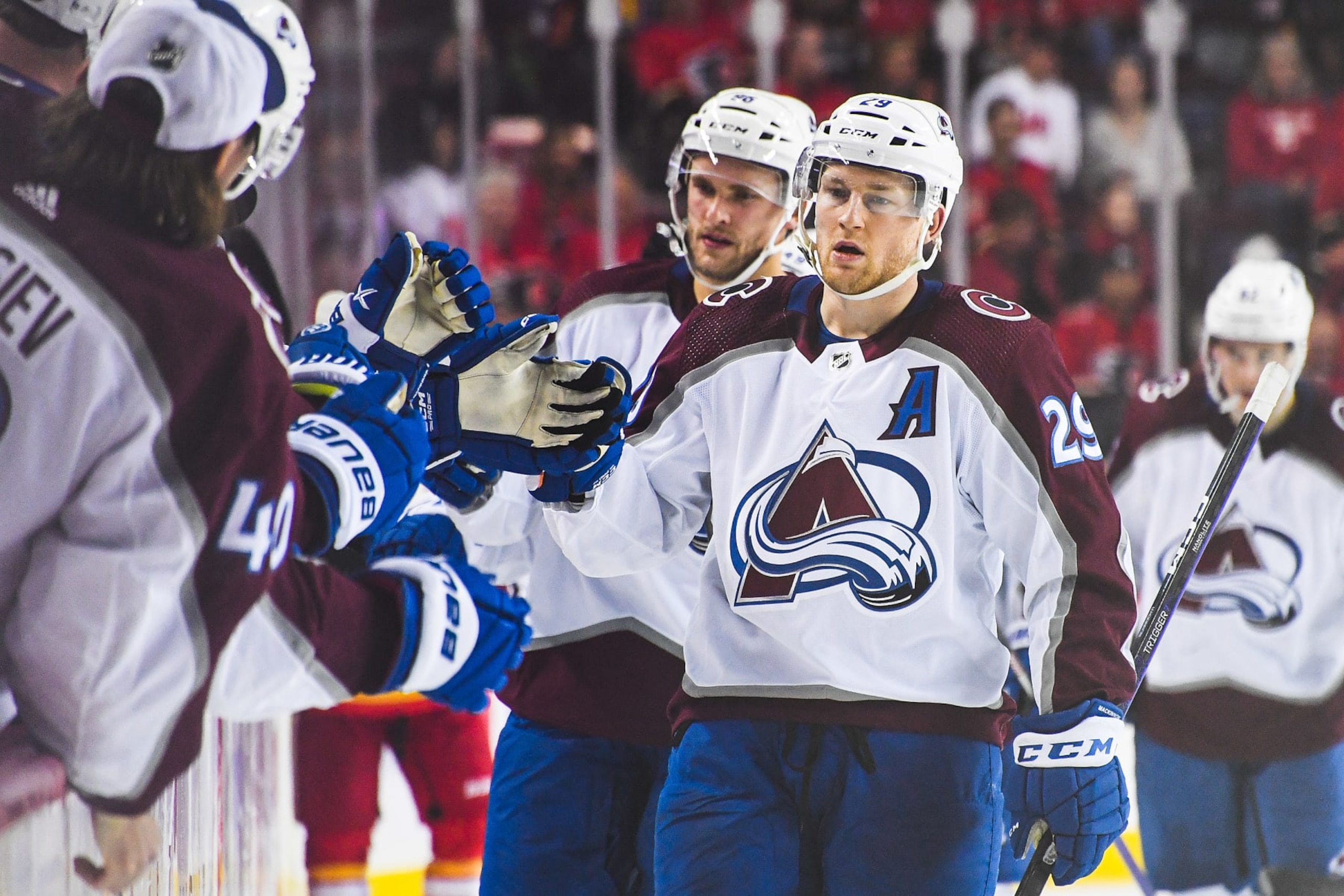 CALGARY, CANADA - OCTOBER 13: Nathan MacKinnon #29 of the Colorado Avalanche celebrates with the bench after scoring against the Calgary Flames during an NHL game at Scotiabank Saddledome on October 13, 2022 in Calgary, Alberta, Canada. (Photo by Derek Leung/Getty Images)