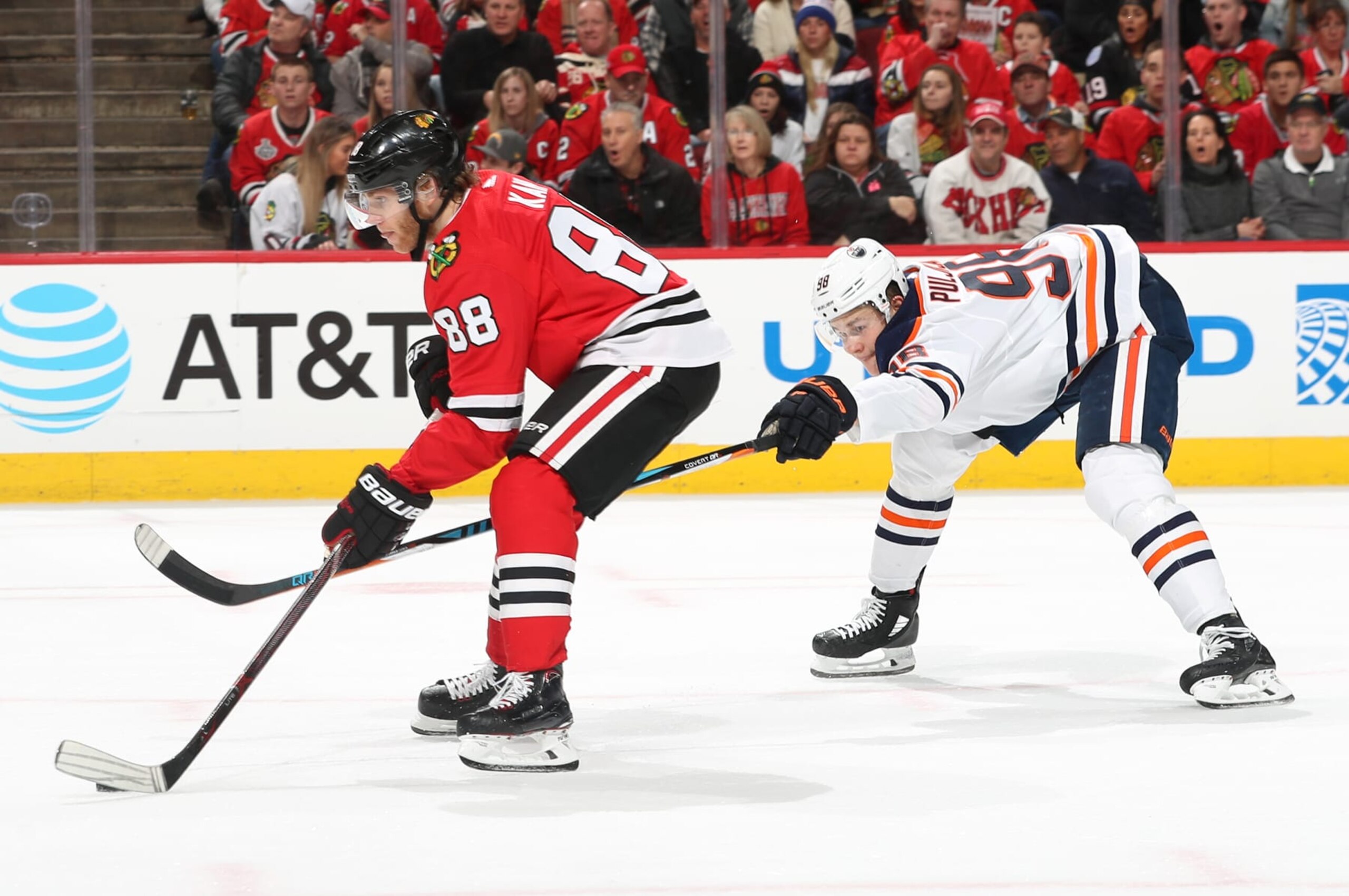 CHICAGO, IL - JANUARY 07:  Patrick Kane #88 of the Chicago Blackhawks controls the puck ahead of Jesse Puljujarvi #98 of the Edmonton Oilers in the second period at the United Center on January 7, 2018 in Chicago, Illinois.  (Photo by Chase Agnello-Dean/NHLI via Getty Images)