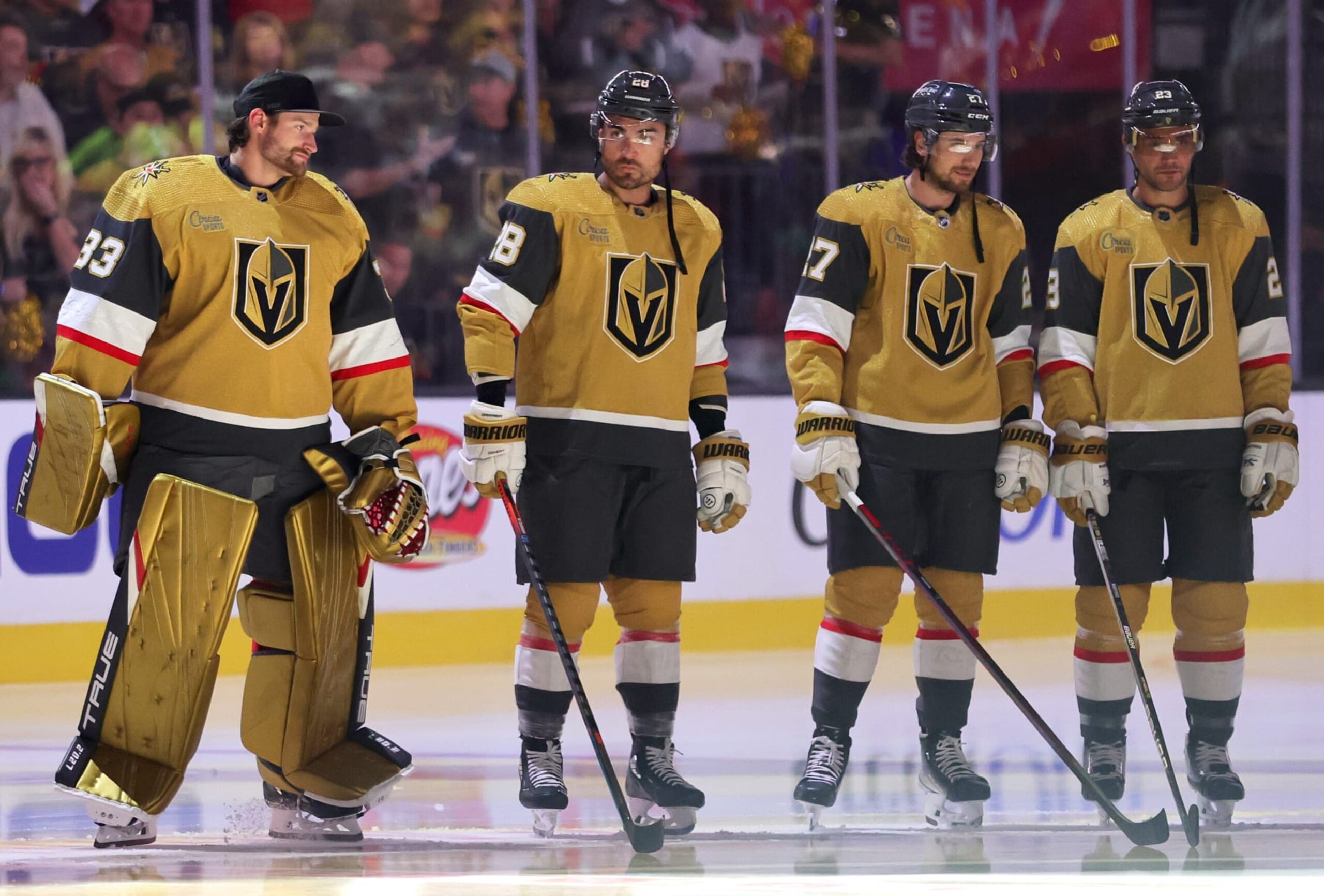 LAS VEGAS, NEVADA - OCTOBER 13: Adin Hill #33, William Carrier #28, Shea Theodore #27 and Alec Martinez #23 of the Vegas Golden Knights are introduced before the team's home opener against the Chicago Blackhawks at T-Mobile Arena on October 13, 2022 in Las Vegas, Nevada. The Golden Knights defeated the Blackhawks 1-0. (Photo by Ethan Miller/Getty Images)