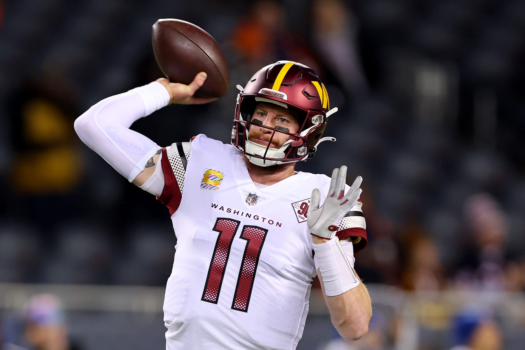 CHICAGO, ILLINOIS - OCTOBER 13: Carson Wentz #11 of the Washington Commanders warms up before the game against the Chicago Bears at Soldier Field on October 13, 2022 in Chicago, Illinois. (Photo by Michael Reaves/Getty Images)