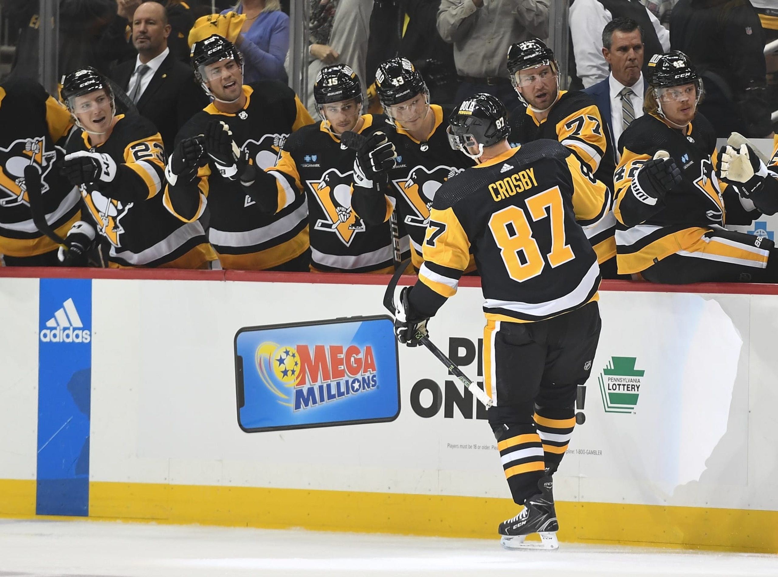 PITTSBURGH, PA - OCTOBER 13: Sidney Crosby #87 of the Pittsburgh Penguins celebrates with teammates on the bench after scoring a goal in the first period during the game against the Arizona Coyotes at PPG PAINTS Arena on October 13, 2022 in Pittsburgh, Pennsylvania. (Photo by Justin Berl/Getty Images)