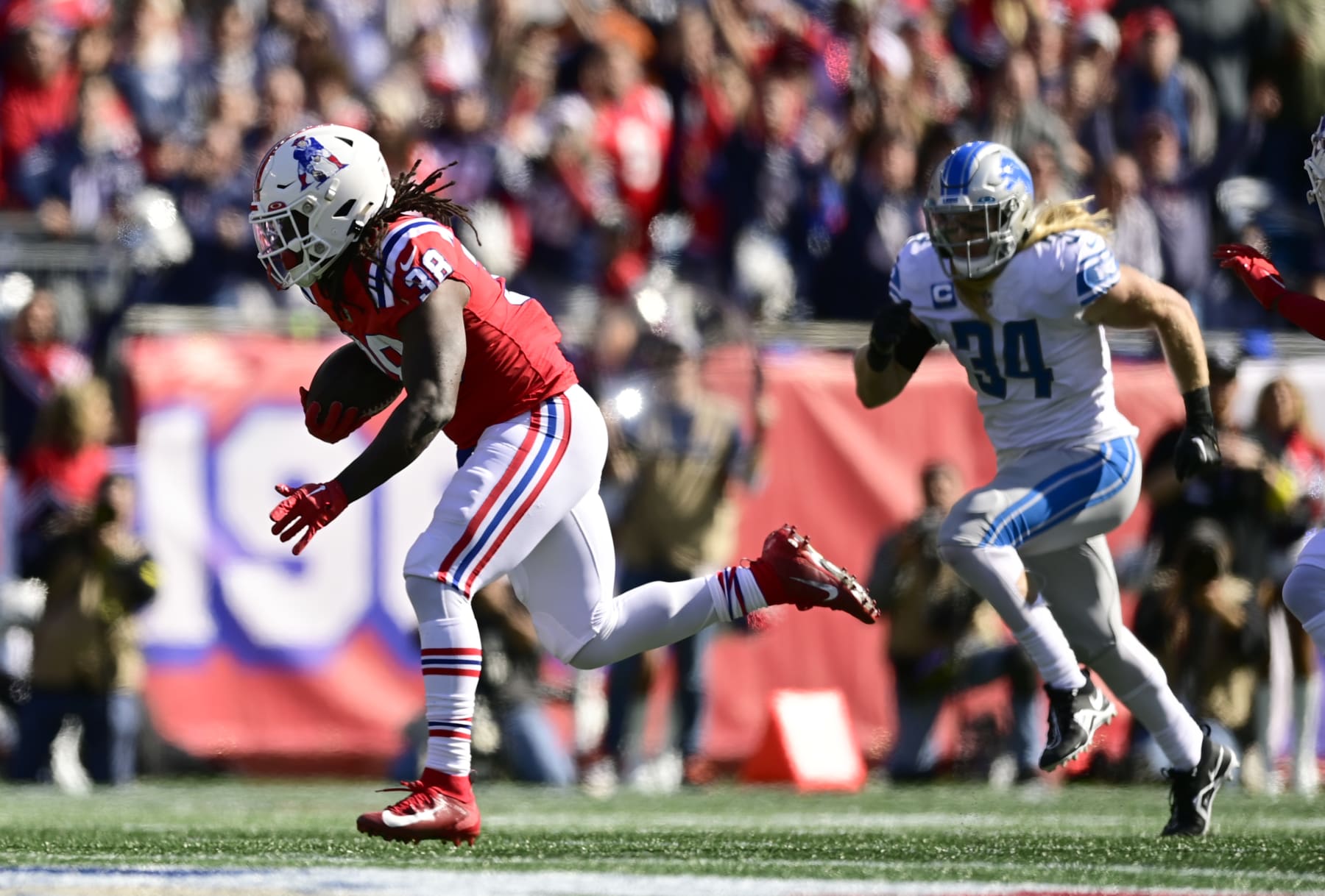 FOXBOROUGH, MASSACHUSETTS - OCTOBER 09: Rhamondre Stevenson #38 of the New England Patriots runs the ball in front of Alex Anzalone #34 of the Detroit Lions during the first quarter at Gillette Stadium on October 09, 2022 in Foxborough, Massachusetts. (Photo by Maddie Malhotra/Getty Images)