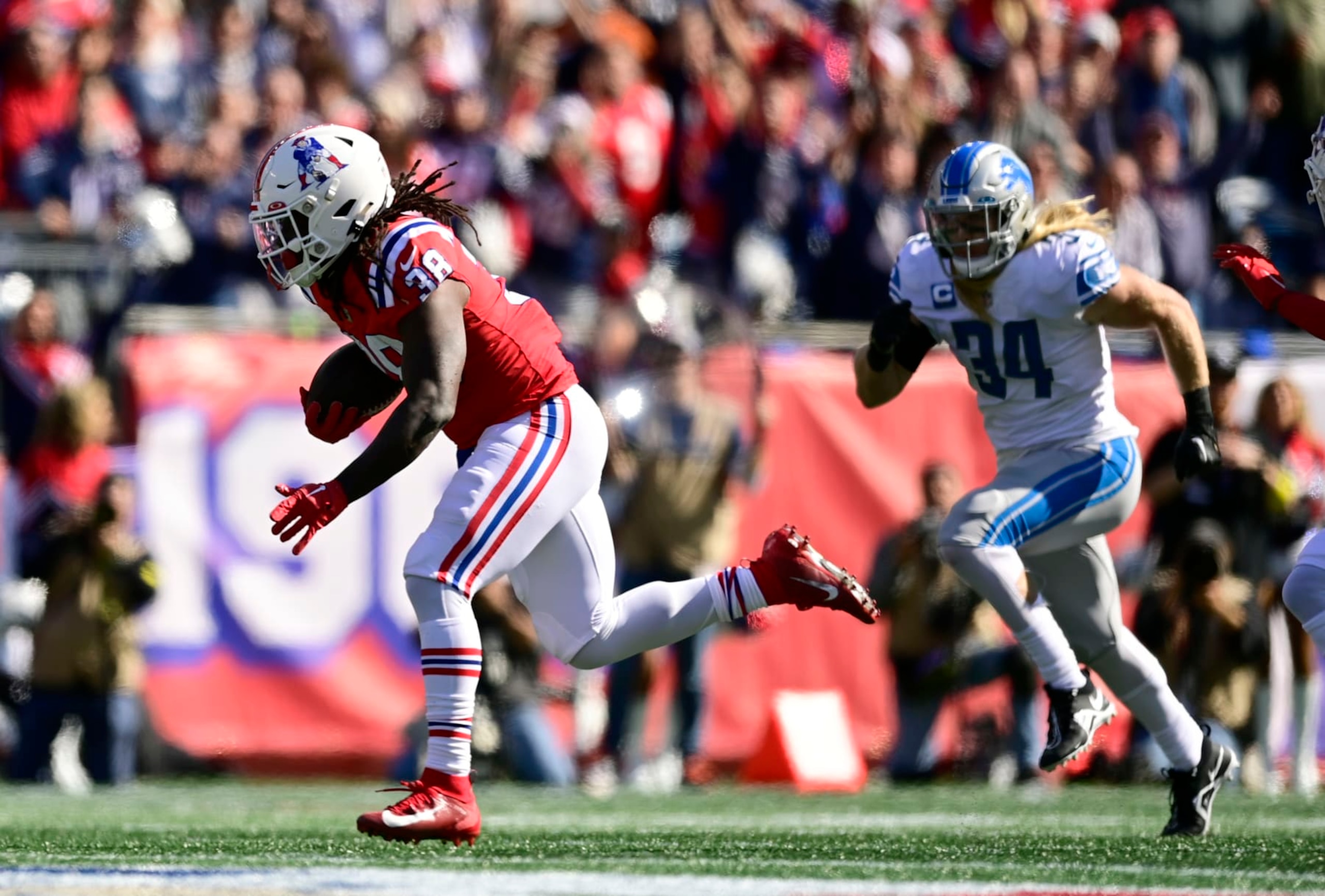 FOXBOROUGH, MASSACHUSETTS - OCTOBER 09: Rhamondre Stevenson #38 of the New England Patriots runs the ball in front of Alex Anzalone #34 of the Detroit Lions during the first quarter at Gillette Stadium on October 09, 2022 in Foxborough, Massachusetts. (Photo by Maddie Malhotra/Getty Images)