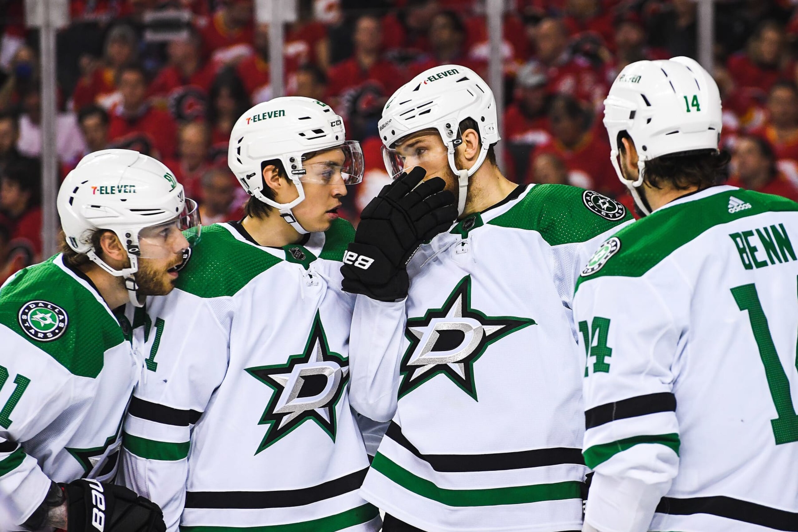 CALGARY, AB - MAY 11: (L-R) Tyler Seguin #91, Jason Robertson #21, Jani Hakanpaa #2 and Jamie Benn #14 of the Dallas Stars confer during a break in first period play against the Calgary Flames in Game Five of the First Round of the 2022 Stanley Cup Playoffs at Scotiabank Saddledome on May 11, 2022 in Calgary, Alberta, Canada. (Photo by Derek Leung/Getty Images)