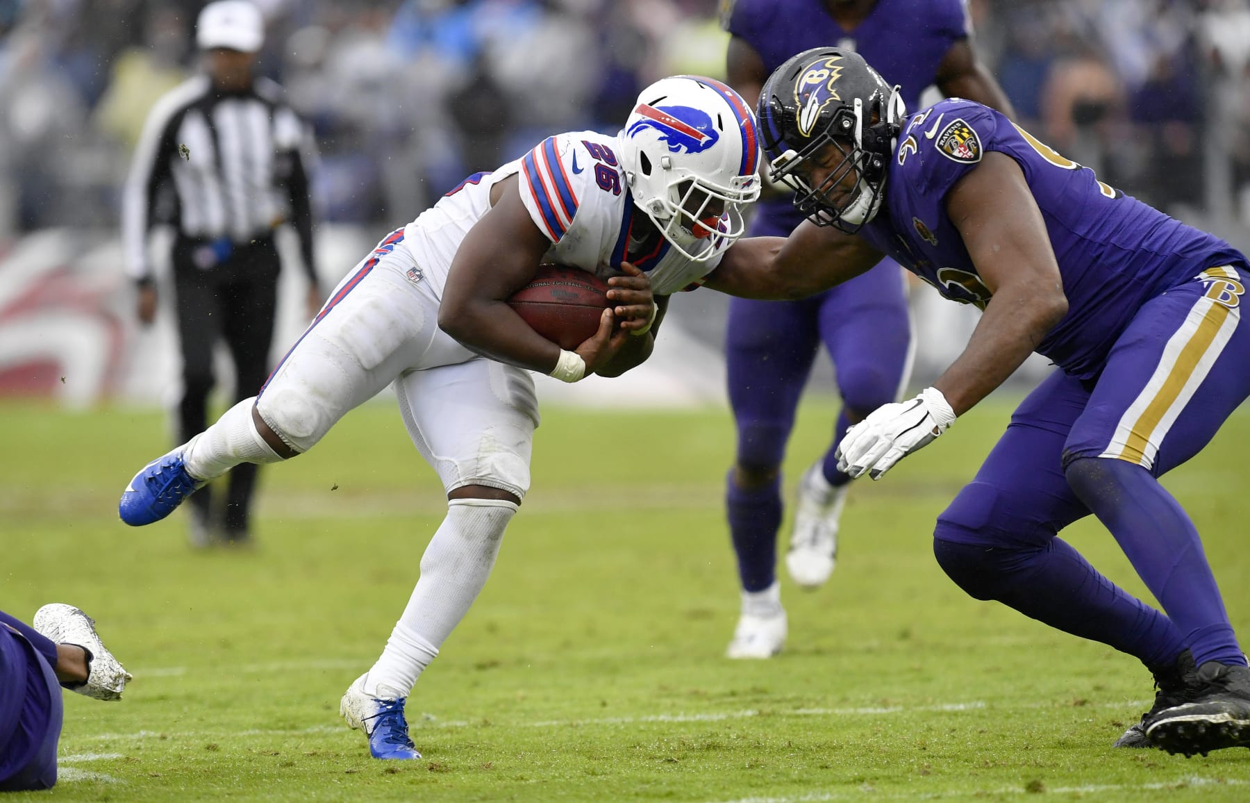 BALTIMORE, MD - OCTOBER 02: Baltimore Ravens defensive tackle Justin Madubuike (92) hits Bills running back Devin Singletary (26) during the Buffalo Bills versus Baltimore Ravens NFL game at M&T Bank Stadium on October 2, 2022 in Baltimore, MD. (Photo by Randy Litzinger/Icon Sportswire via Getty Images)