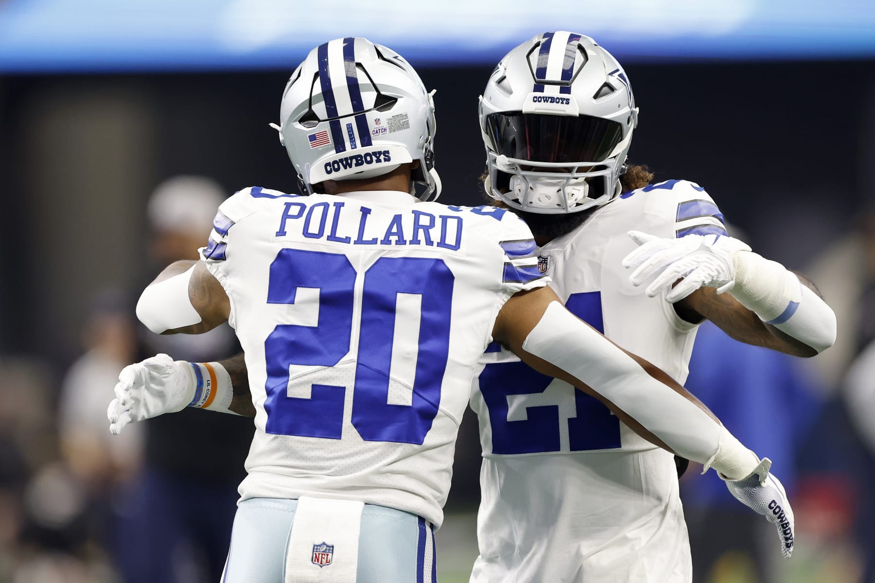 ARLINGTON, TEXAS - OCTOBER 02: Tony Pollard #20 of the Dallas Cowboys and Ezekiel Elliott #21 of the Dallas Cowboys embrace during warm ups against the Washington Commanders at AT&T Stadium on October 02, 2022 in Arlington, Texas. (Photo by Wesley Hitt/Getty Images)