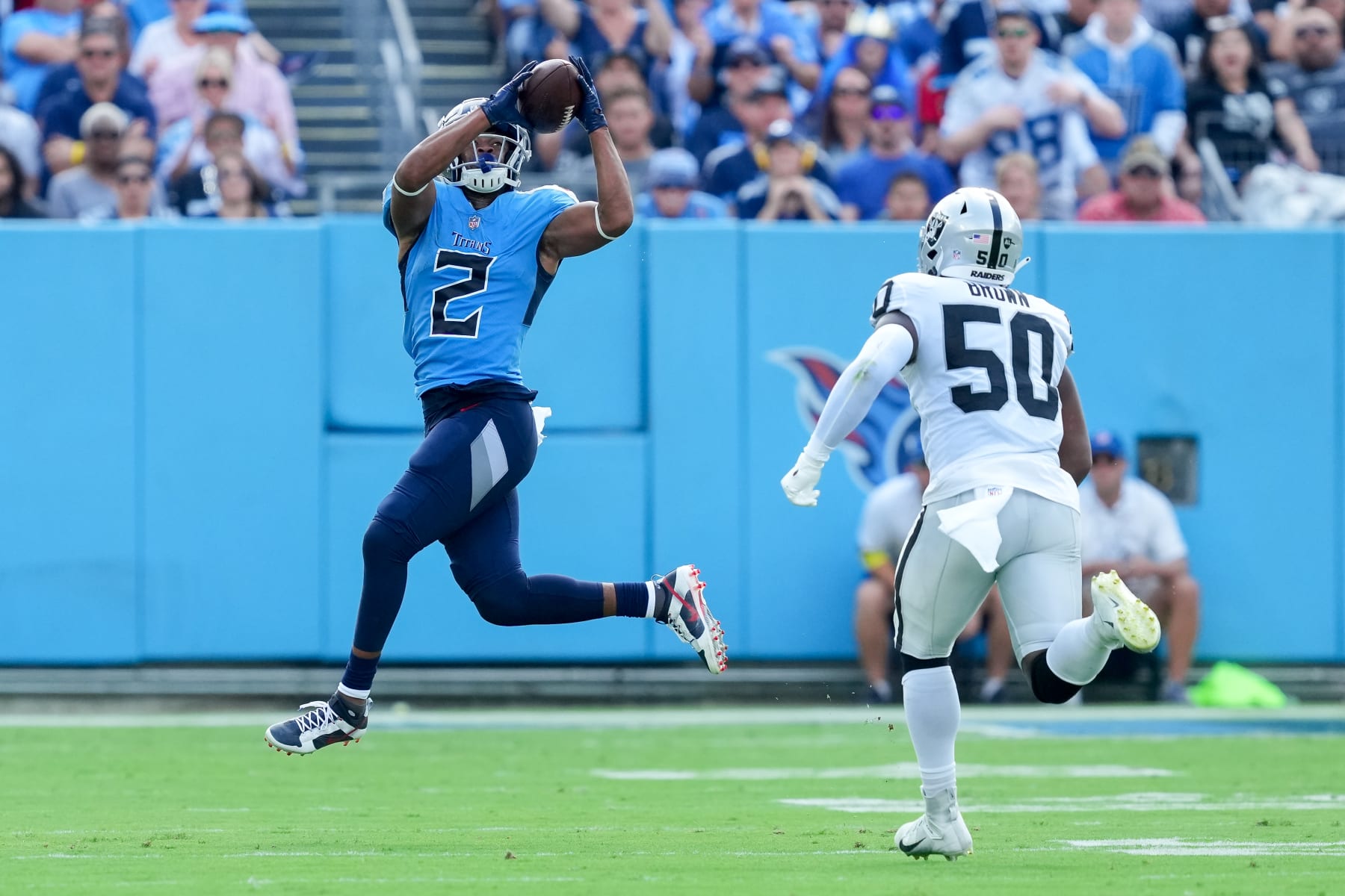 NASHVILLE, TENNESSEE - SEPTEMBER 25: Robert Woods #2 of the Tennessee Titans makes a catch past Jayon Brown #50 of the Las Vegas Raiders in the first quarter at Nissan Stadium on September 25, 2022 in Nashville, Tennessee. (Photo by Dylan Buell/Getty Images)