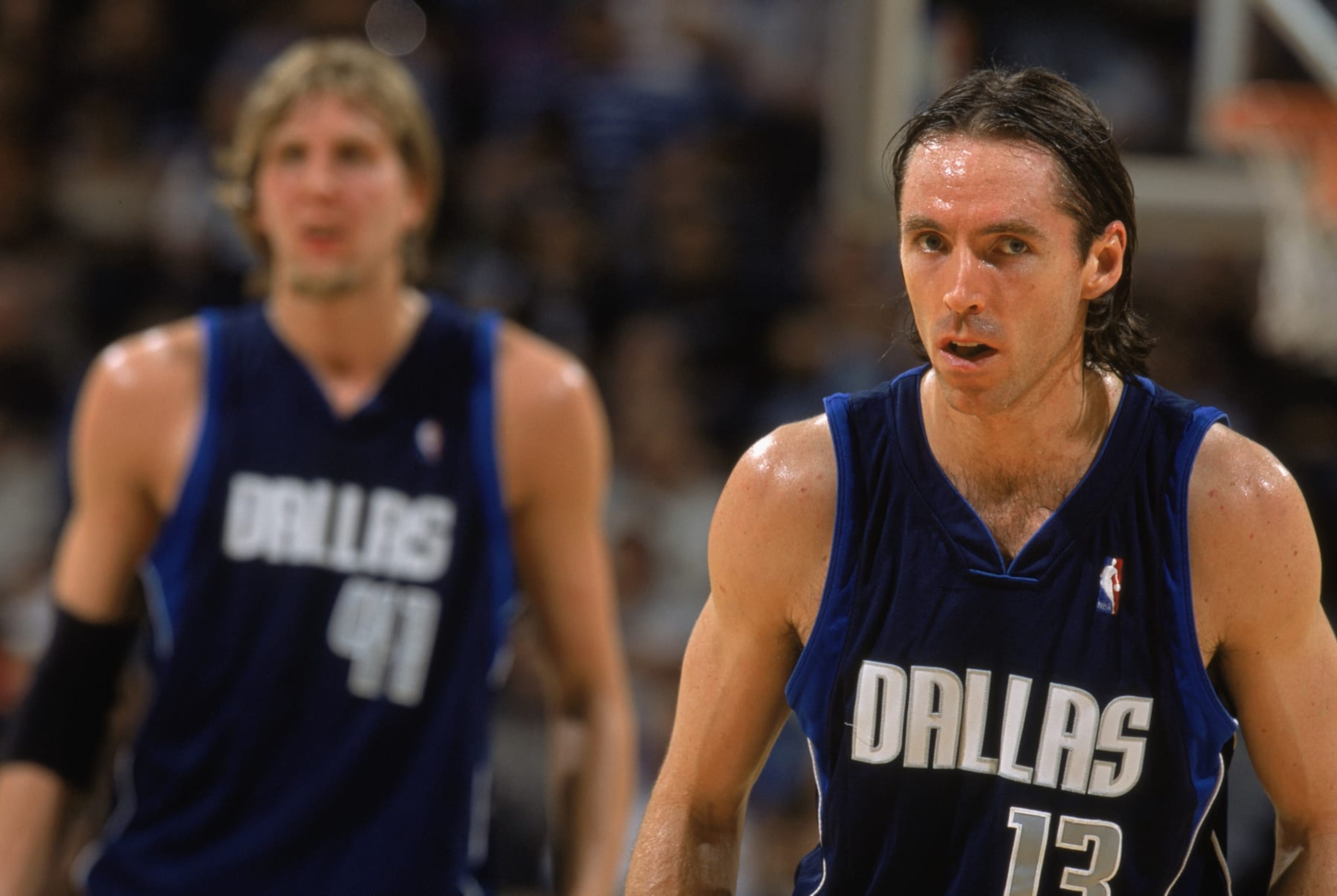 SAN ANTONIO - MAY 21:  Steve Nash #13 and Dirk Nowitzki #41 of the Dallas Mavericks wait for play to begin in Game Two of the Western Conference Finals against the San Antonio Spurs during the 2003 NBA Playoffs at SBC Center on May 21, 2003 in San Antonio, Texas. The Spurs won 119-106.  NOTE TO USER: User expressly acknowledges and agrees that, by downloading and/or using this Photograph, User is consenting to the terms and conditions of the Getty Images License Agreement. Mandatory copyright notice:  Copyright 2003 NBAE (Photo by: Andrew D. Bernstein/NBAE via Getty Images)