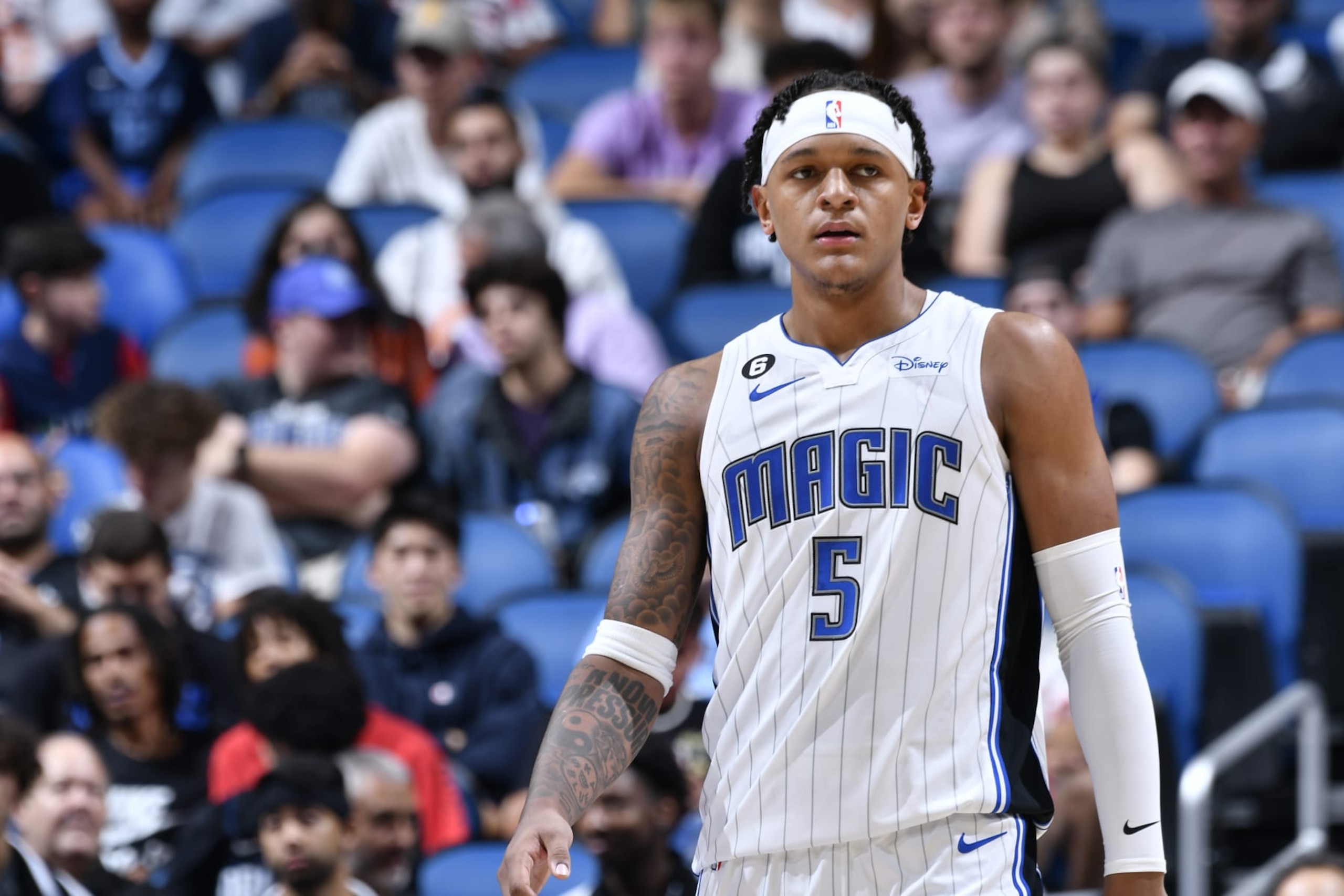 ORLANDO, FL - OCTOBER 11: Paolo Banchero #5 of the Orlando Magic looks on during the game against the Memphis Grizzlies on October 11, 2022 at Amway Center in Orlando, Florida. NOTE TO USER: User expressly acknowledges and agrees that, by downloading and or using this photograph, User is consenting to the terms and conditions of the Getty Images License Agreement. Mandatory Copyright Notice: Copyright 2022 NBAE (Photo by Fernando Medina/NBAE via Getty Images) ORLANDO, FL - OCTOBER 11: Paolo Banchero #5 of the Orlando Magic looks on during the game against the Memphis Grizzlies on October 11, 2022 at Amway Center in Orlando, Florida. NOTE TO USER: User expressly acknowledges and agrees that, by downloading and or using this photograph, User is consenting to the terms and conditions of the Getty Images License Agreement. Mandatory Copyright Notice: Copyright 2022 NBAE (Photo by Fernando Medina/NBAE via Getty Images)
