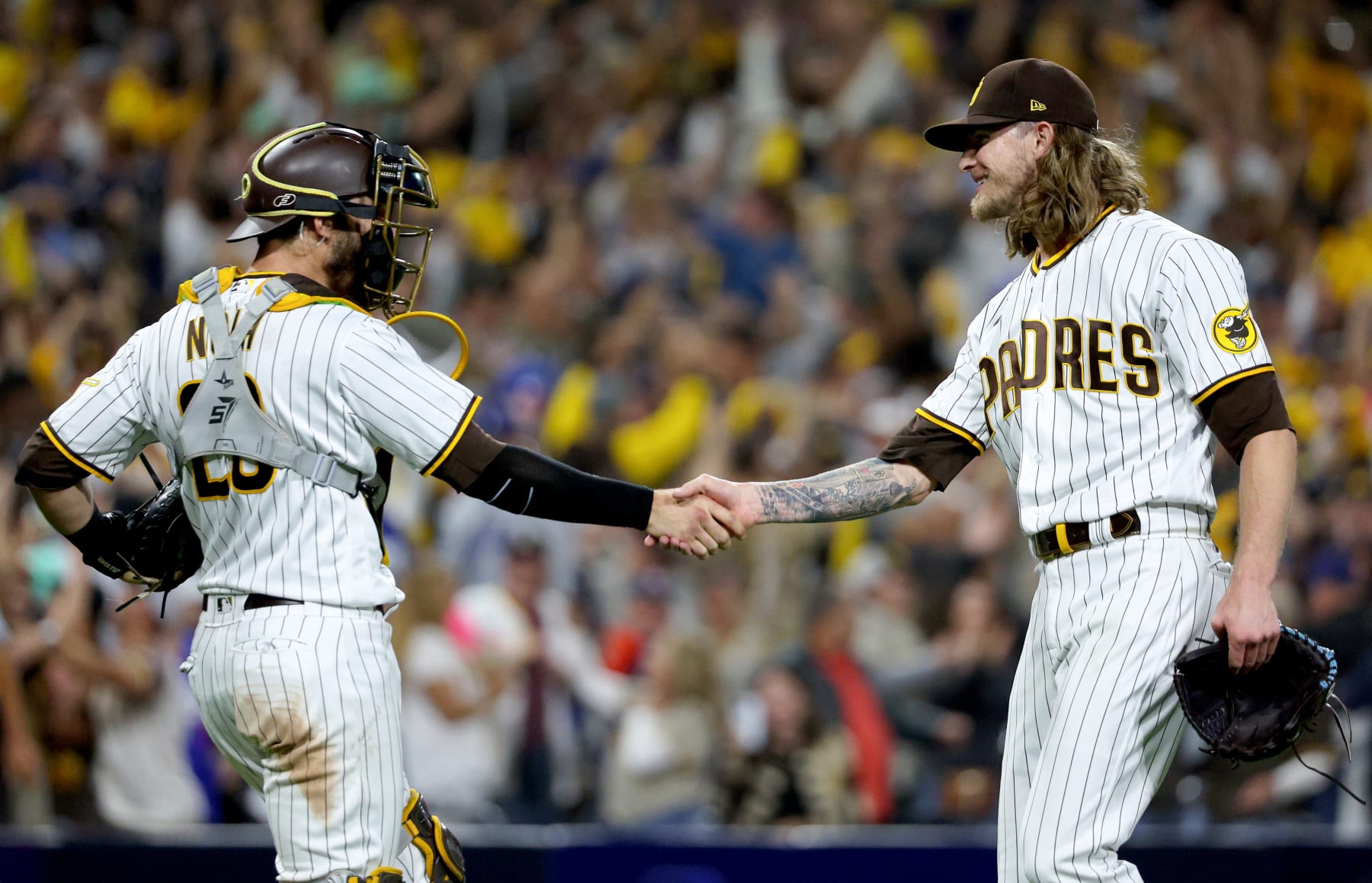 SAN DIEGO, CALIFORNIA - OCTOBER 14: Austin Nola #26 and Josh Hader #71 of the San Diego Padres celebrate after defeating the Los Angeles Dodgers in game three of the National League Division Series at PETCO Park on October 14, 2022 in San Diego, California. (Photo by Harry How/Getty Images)