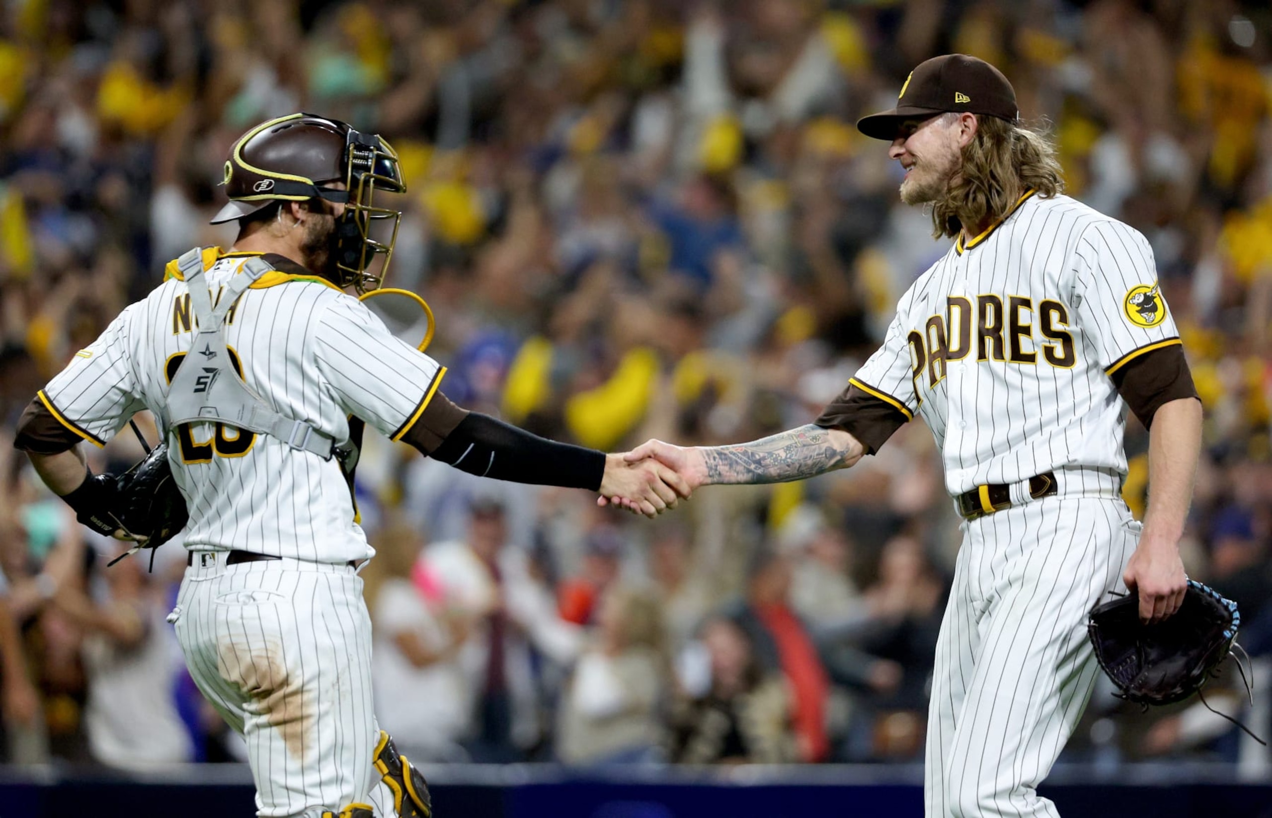 SAN DIEGO, CALIFORNIA - OCTOBER 14: Austin Nola #26 and Josh Hader #71 of the San Diego Padres celebrate after defeating the Los Angeles Dodgers in game three of the National League Division Series at PETCO Park on October 14, 2022 in San Diego, California. (Photo by Harry How/Getty Images)