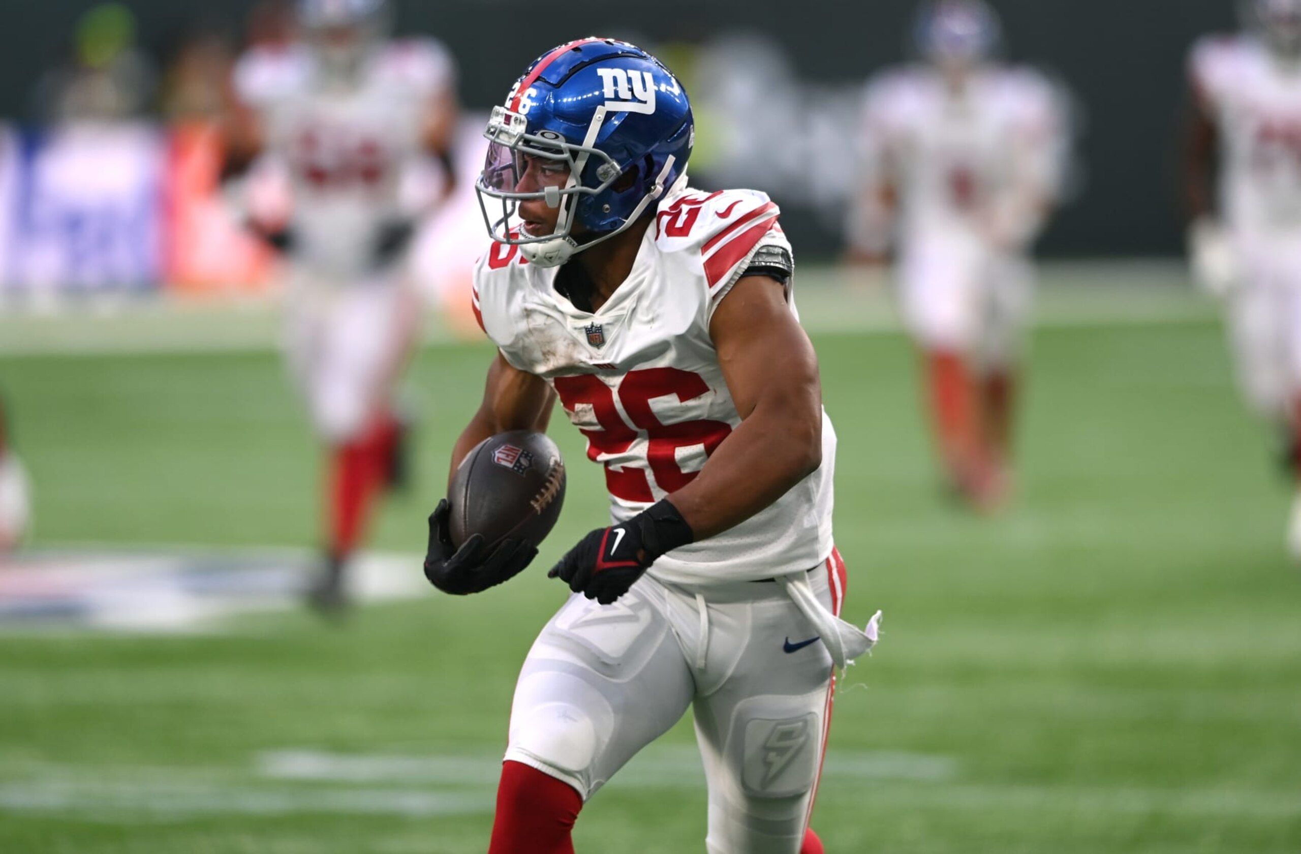 LONDON, ENGLAND - OCTOBER 09: Saquon Barkley #26 of the New York Giants rushes for a big gain during the NFL match between New York Giants and Green Bay Packers at Tottenham Hotspur Stadium on October 09, 2022 in London, England. (Photo by Stu Forster/Getty Images)