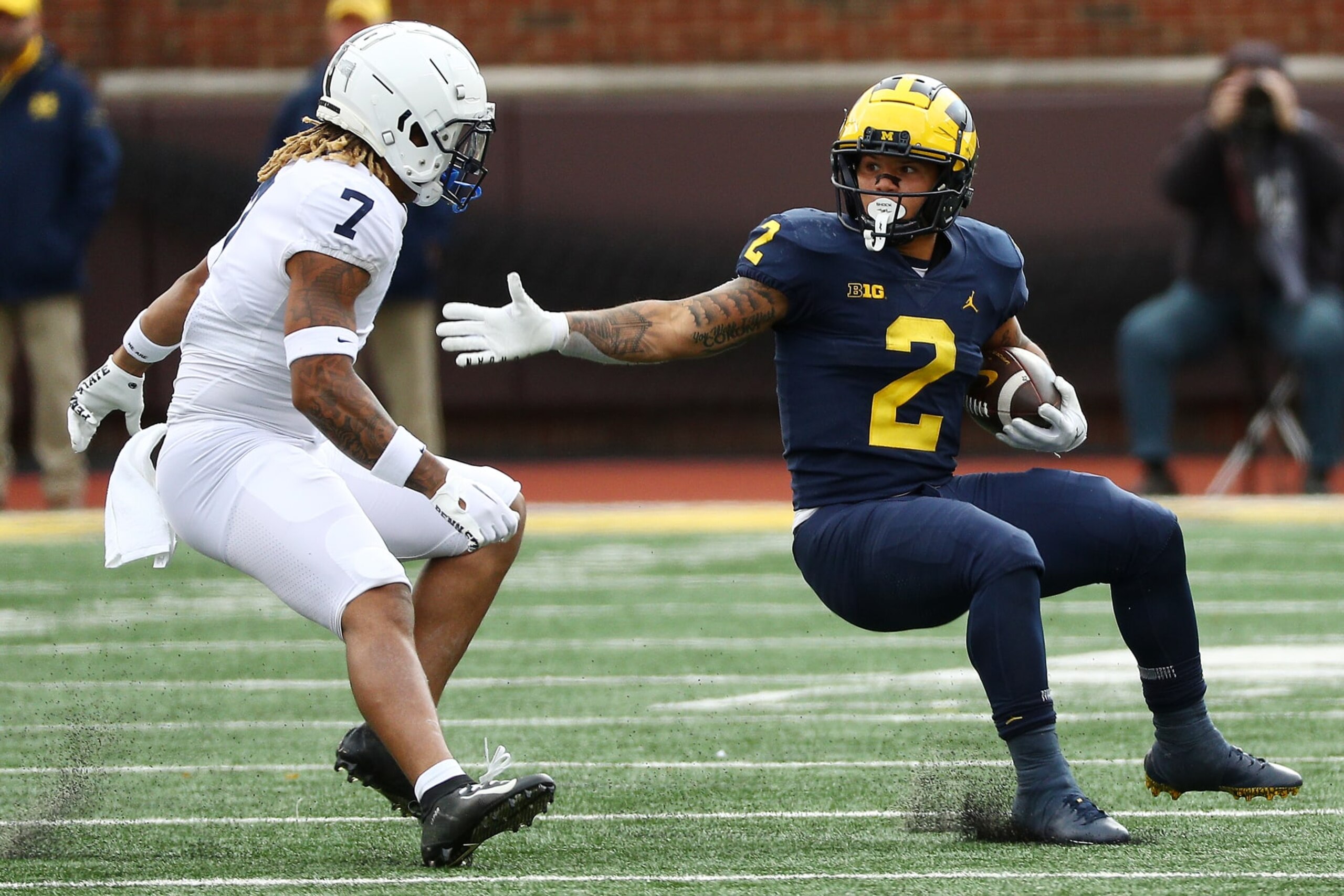 ANN ARBOR, MICHIGAN - OCTOBER 15: Blake Corum #2 of the Michigan Wolverines looks to avoid a tackle by Jaylen Reed #7 of the Penn State Nittany Lions in the first half of a game at Michigan Stadium on October 15, 2022 in Ann Arbor, Michigan. (Photo by Mike Mulholland/Getty Images)