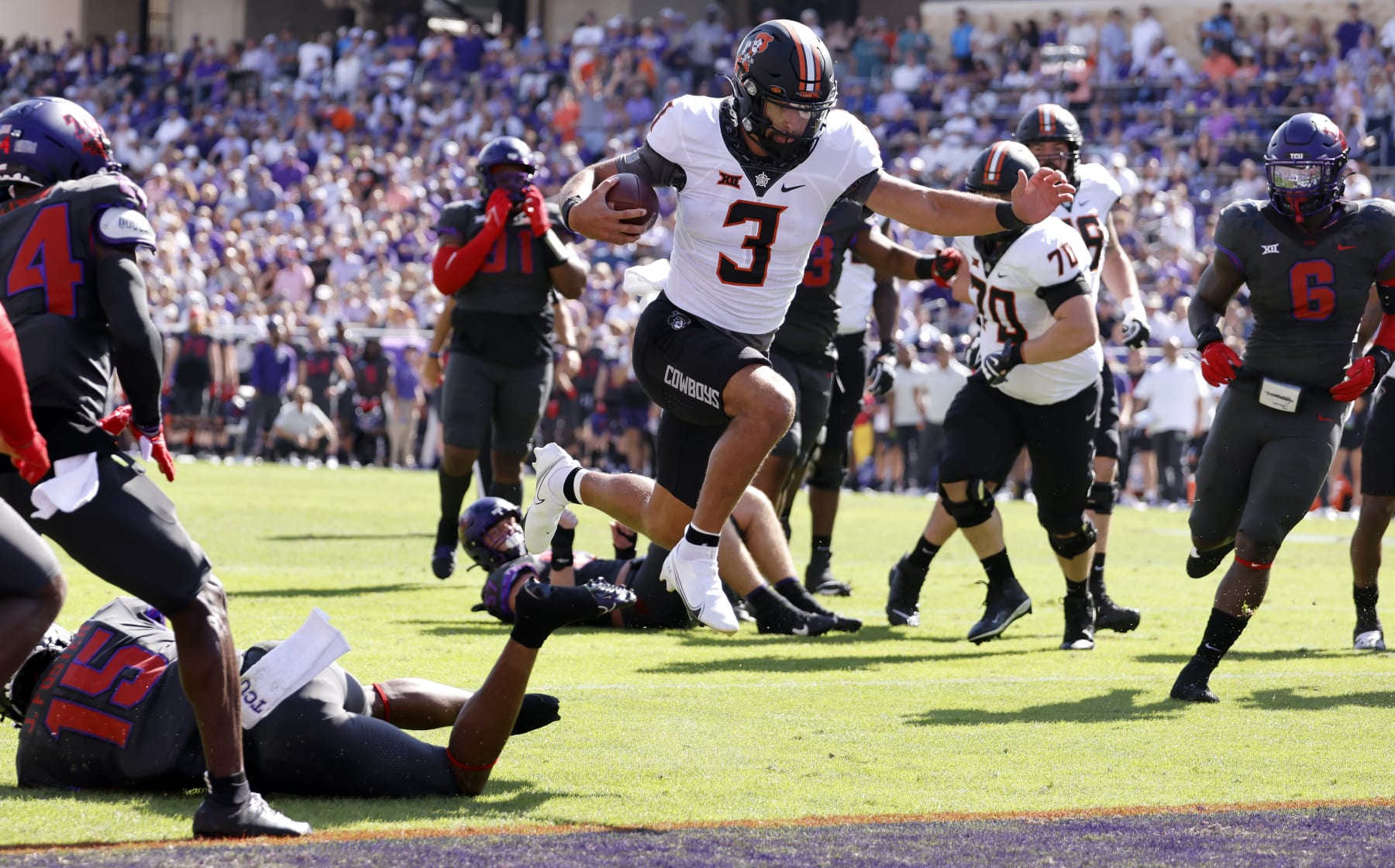 FORT WORTH, TX - OCTOBER 15: Spencer Sanders #3 of the Oklahoma State Cowboys leaps across the the goal line to score a touchdown against the TCU Horned Frogs during the first half at Amon G. Carter Stadium on October 15, 2022 in Fort Worth, Texas. (Photo by Ron Jenkins/Getty Images)