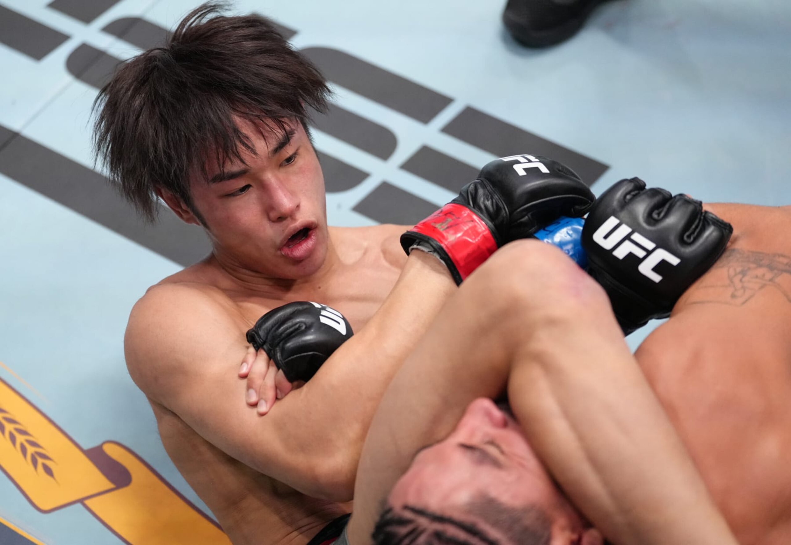 LAS VEGAS, NEVADA - OCTOBER 15: (L-R) Tatsuro Taira of Japan secures an arm bar submission against CJ Vergara in a flyweight fight during the UFC Fight Night event at UFC APEX on October 15, 2022 in Las Vegas, Nevada. (Photo by Jeff Bottari/Zuffa LLC)