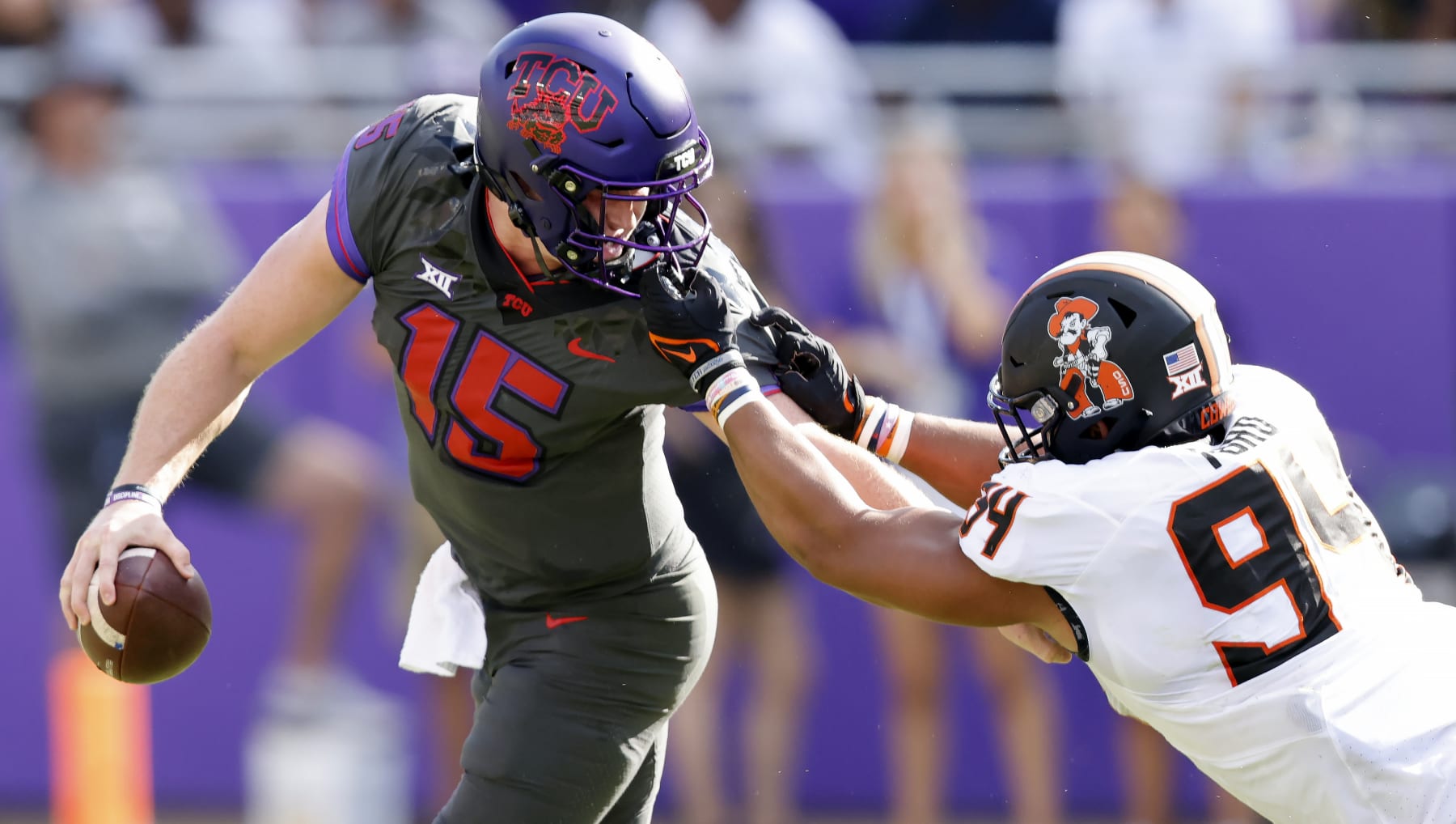 FORT WORTH, TX - OCTOBER 15: Max Duggan #15 of the TCU Horned Frogs is brought down by his face mask by Brock Martin #9 of the Oklahoma State Cowboys during the first half at Amon G. Carter Stadium on October 15, 2022 in Fort Worth, Texas. (Photo by Ron Jenkins/Getty Images)