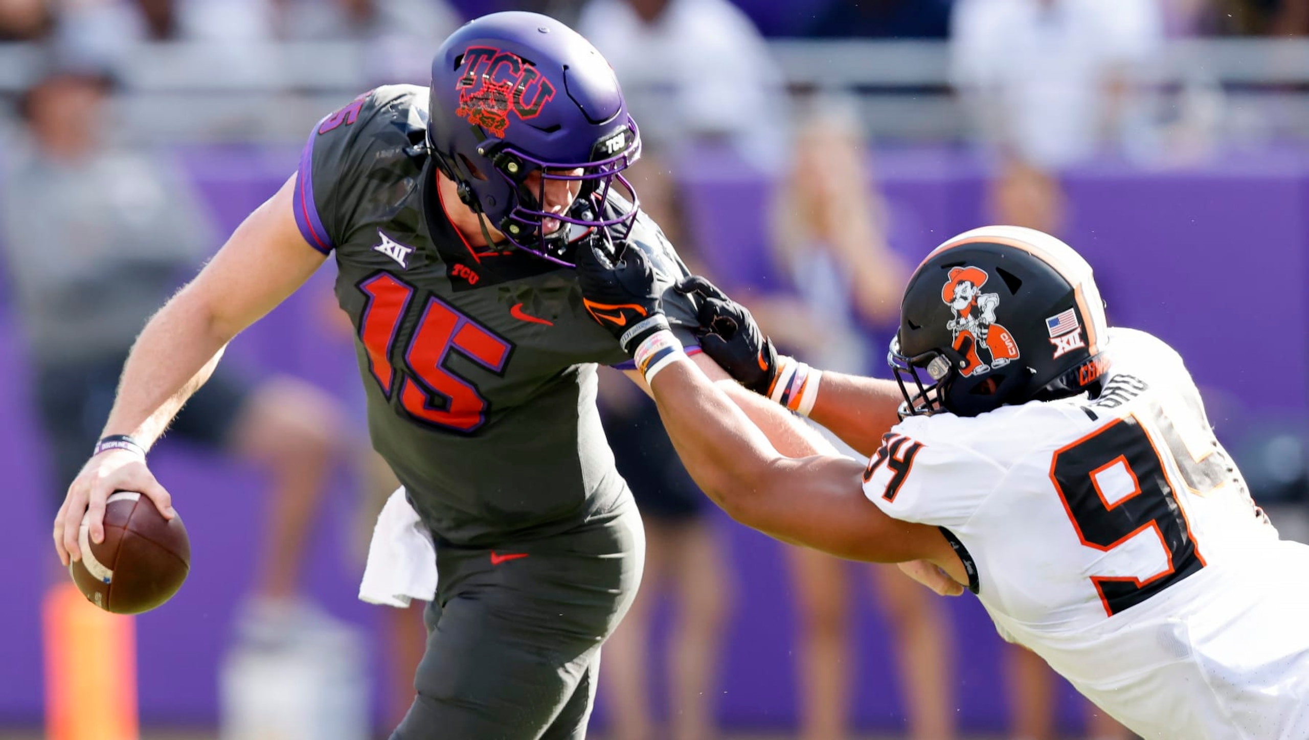FORT WORTH, TX - OCTOBER 15: Max Duggan #15 of the TCU Horned Frogs is brought down by his face mask by Brock Martin #9 of the Oklahoma State Cowboys during the first half at Amon G. Carter Stadium on October 15, 2022 in Fort Worth, Texas. (Photo by Ron Jenkins/Getty Images)