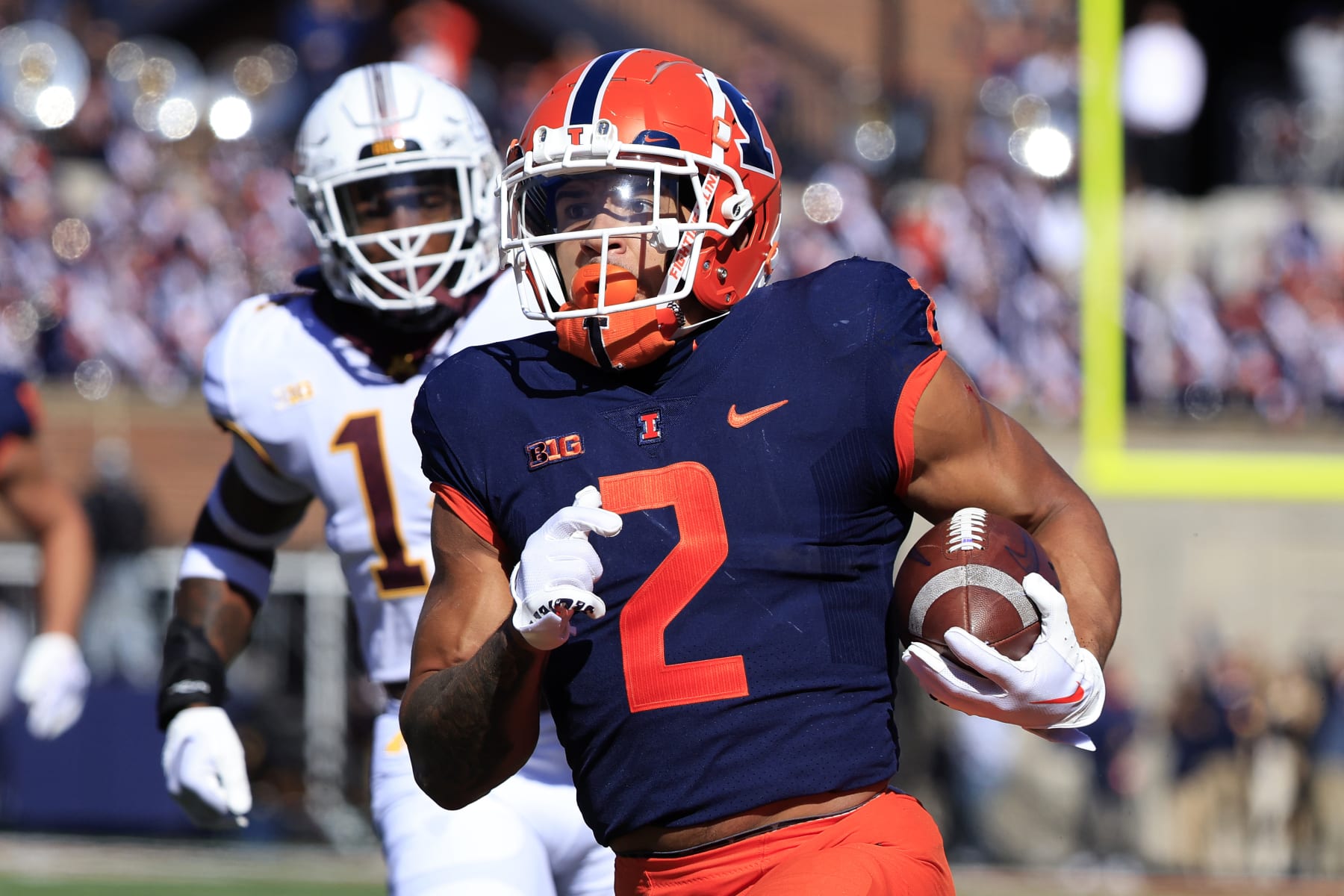 CHAMPAIGN, ILLINOIS - OCTOBER 15: Chase Brown #2 of the Illinois Fighting Illini runs the ball for a touchdown during the first half in the game against the Minnesota Golden Gophers at Memorial Stadium on October 15, 2022 in Champaign, Illinois. (Photo by Justin Casterline/Getty Images)