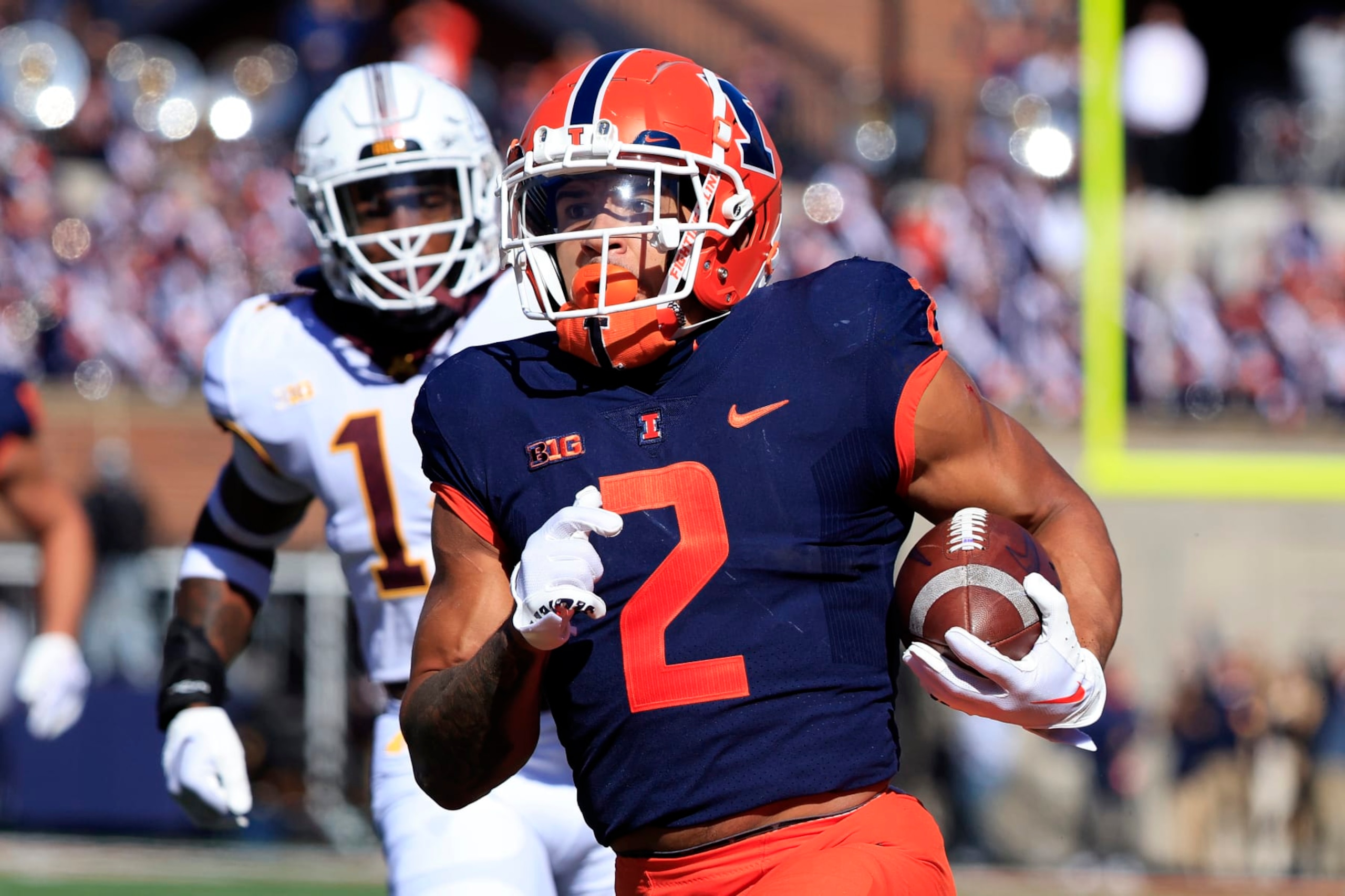 CHAMPAIGN, ILLINOIS - OCTOBER 15: Chase Brown #2 of the Illinois Fighting Illini runs the ball for a touchdown during the first half in the game against the Minnesota Golden Gophers at Memorial Stadium on October 15, 2022 in Champaign, Illinois. (Photo by Justin Casterline/Getty Images)