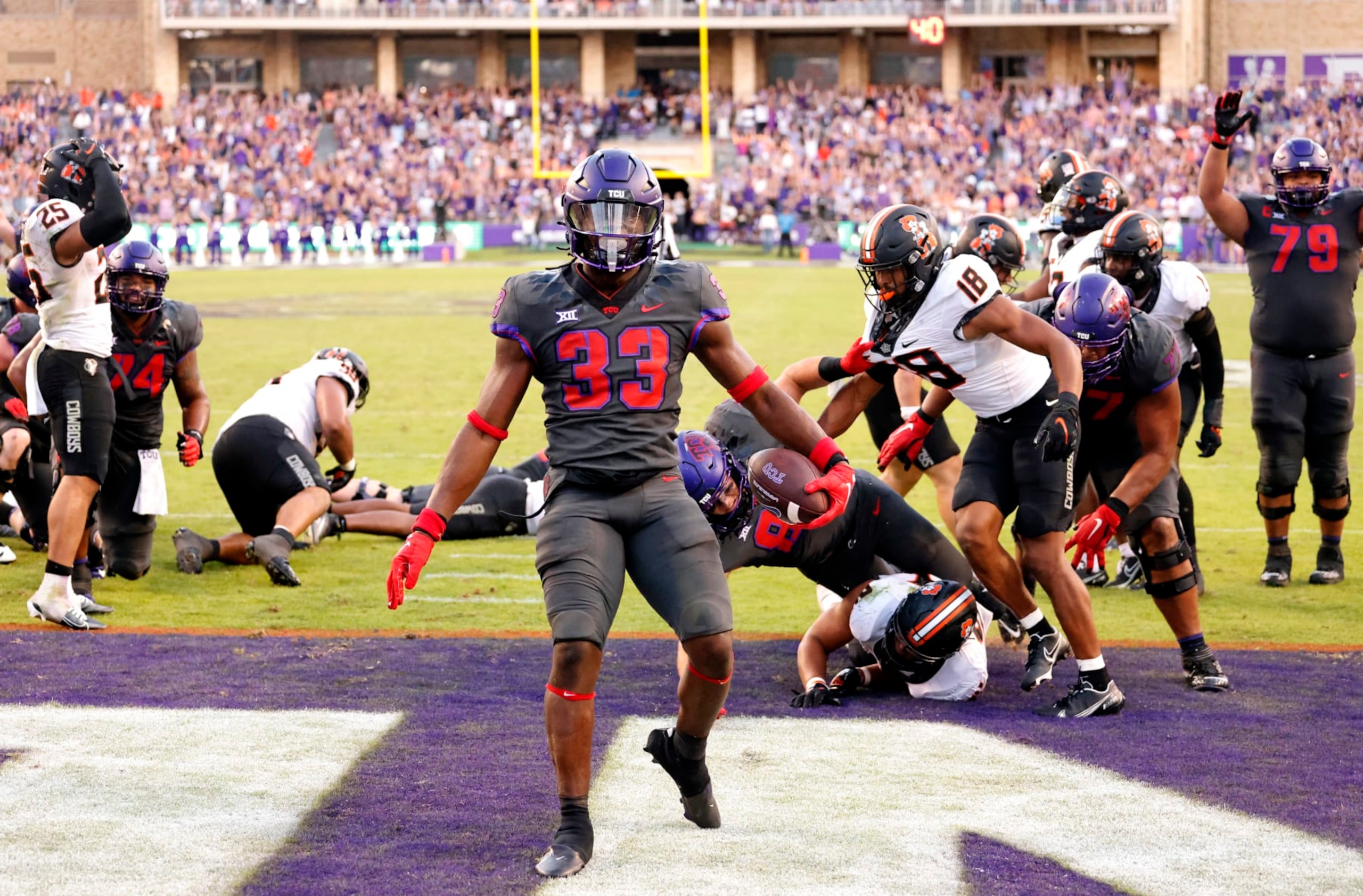 FORT WORTH, TX - OCTOBER 15: Kendre Miller #33 of the TCU Horned Frogs reacts following his game winning touchdown run against the Oklahoma State Cowboys during the second overtime at Amon G. Carter Stadium on October 15, 2022 in Fort Worth, Texas. TCU won 43-40. (Photo by Ron Jenkins/Getty Images)