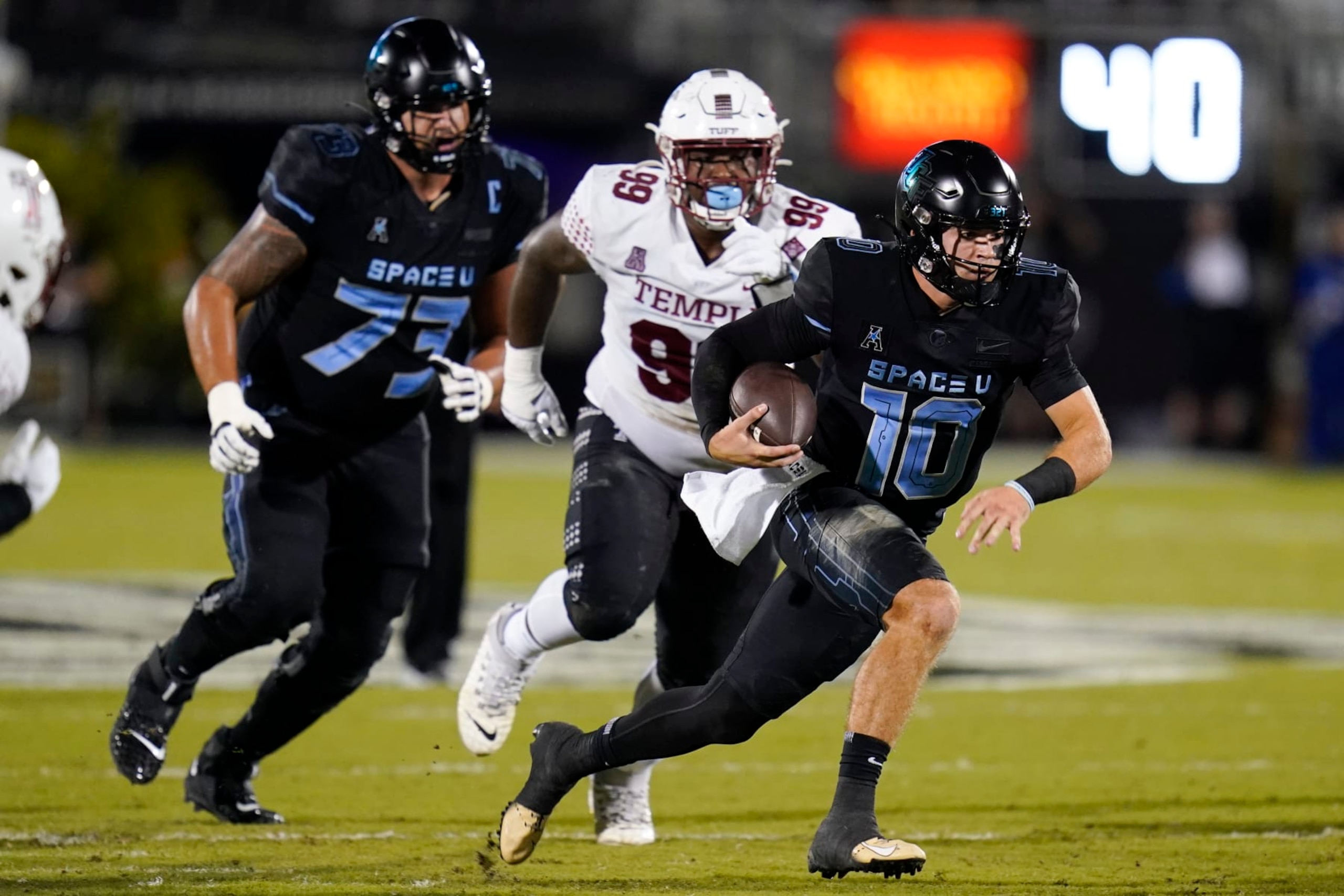 Central Florida quarterback John Rhys Plumlee (10) runs past Temple defensive lineman Demerick Morris (99) during the first half of an NCAA college football game Thursday, Oct. 13, 2022, in Orlando, Fla. (AP Photo/John Raoux)