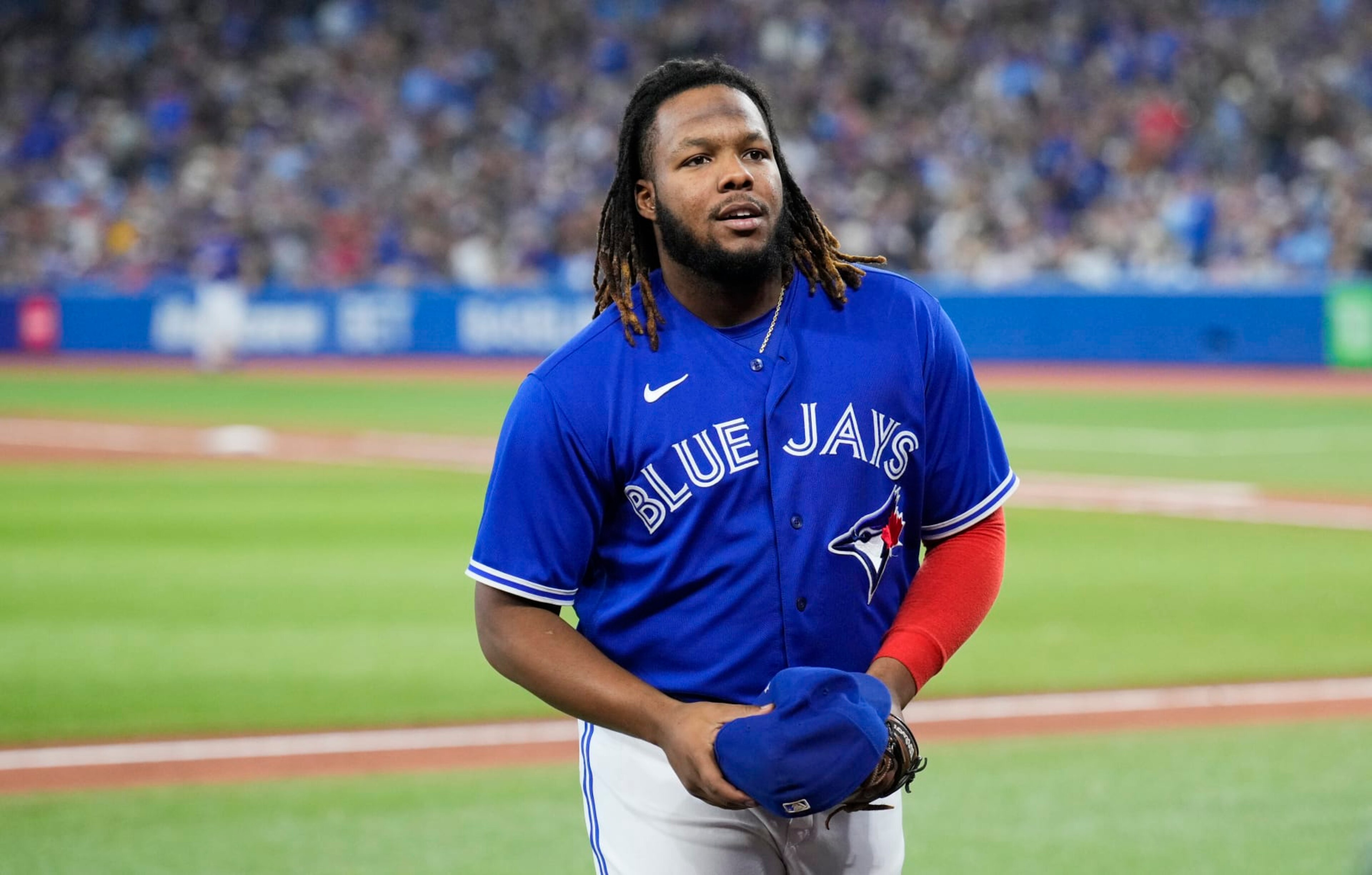TORONTO, ON - OCTOBER 2: Vladimir Guerrero Jr. #27 of the Toronto Blue Jays smiles after coming off the field against the Boston Red Sox during the seventh inning in their MLB game at the Rogers Centre on October 2, 2022 in Toronto, Ontario, Canada. (Photo by Mark Blinch/Getty Images) TORONTO, ON - OCTOBER 2: Vladimir Guerrero Jr. #27 of the Toronto Blue Jays smiles after coming off the field against the Boston Red Sox during the seventh inning in their MLB game at the Rogers Centre on October 2, 2022 in Toronto, Ontario, Canada. (Photo by Mark Blinch/Getty Images)