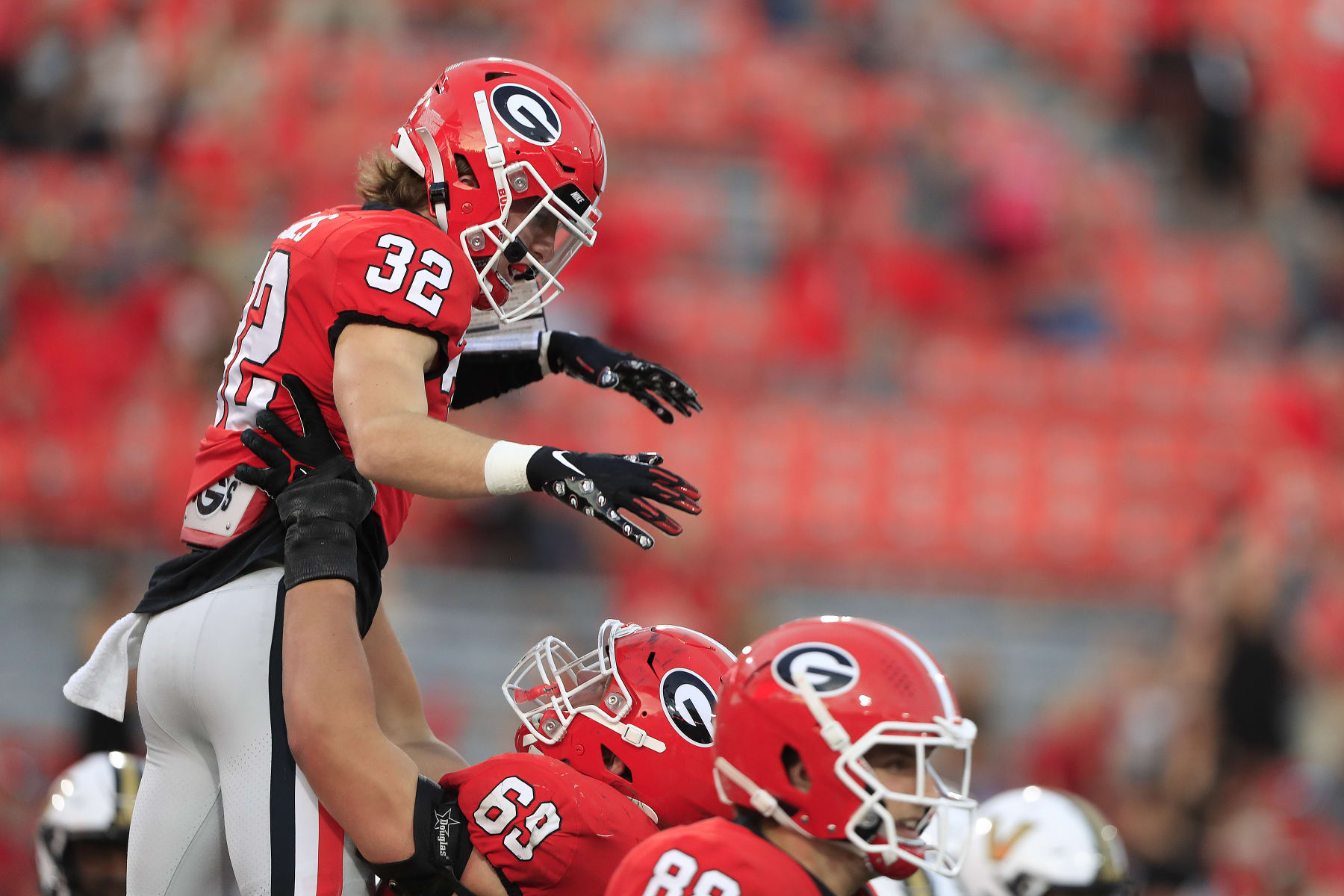 ATHENS, GA - OCTOBER 15: Georgia Bulldogs running back Cash Jones (32) is lifted in the air after scoring a touchdown during the college football game between the Georgia Bulldogs and the Vanderbilt Commodores on October 15, 2022 at Sanford Stadium in Athens, GA.  (Photo by David J. Griffin/Icon Sportswire via Getty Images)