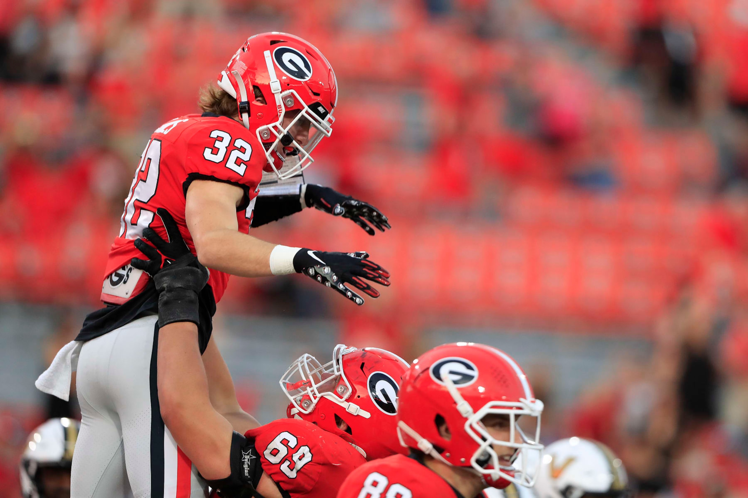 ATHENS, GA - OCTOBER 15: Georgia Bulldogs running back Cash Jones (32) is lifted in the air after scoring a touchdown during the college football game between the Georgia Bulldogs and the Vanderbilt Commodores on October 15, 2022 at Sanford Stadium in Athens, GA.  (Photo by David J. Griffin/Icon Sportswire via Getty Images)