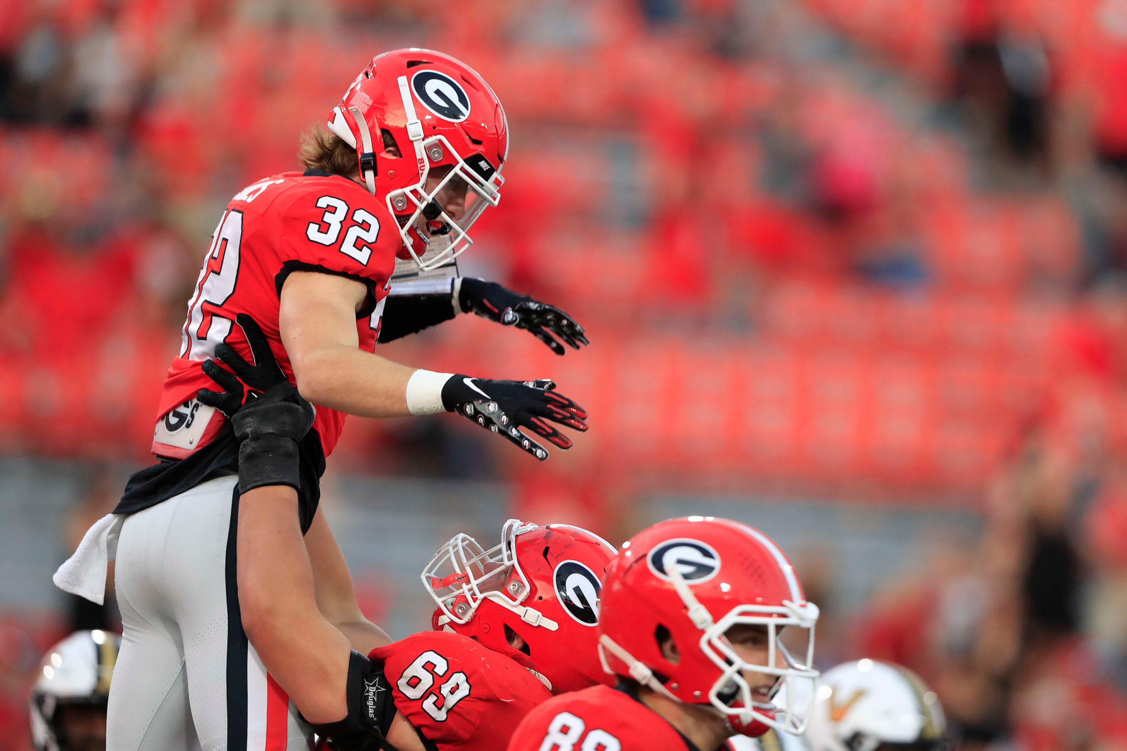 ATHENS, GA - OCTOBER 15: Georgia Bulldogs running back Cash Jones (32) is lifted in the air after scoring a touchdown during the college football game between the Georgia Bulldogs and the Vanderbilt Commodores on October 15, 2022 at Sanford Stadium in Athens, GA.  (Photo by David J. Griffin/Icon Sportswire via Getty Images)