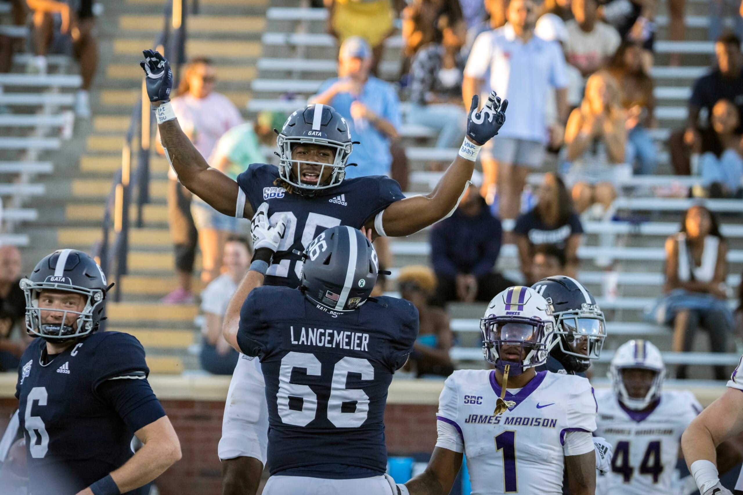 Georgia Southern running back Jalen White (25) celebrates his touchdown with Georgia Southern offensive lineman Logan Langemeier (66) during the second half of an NCAA football game James Madison, Saturday, Oct. 15, 2022, in Statesboro, Ga. (AP Photo/Stephen B. Morton)