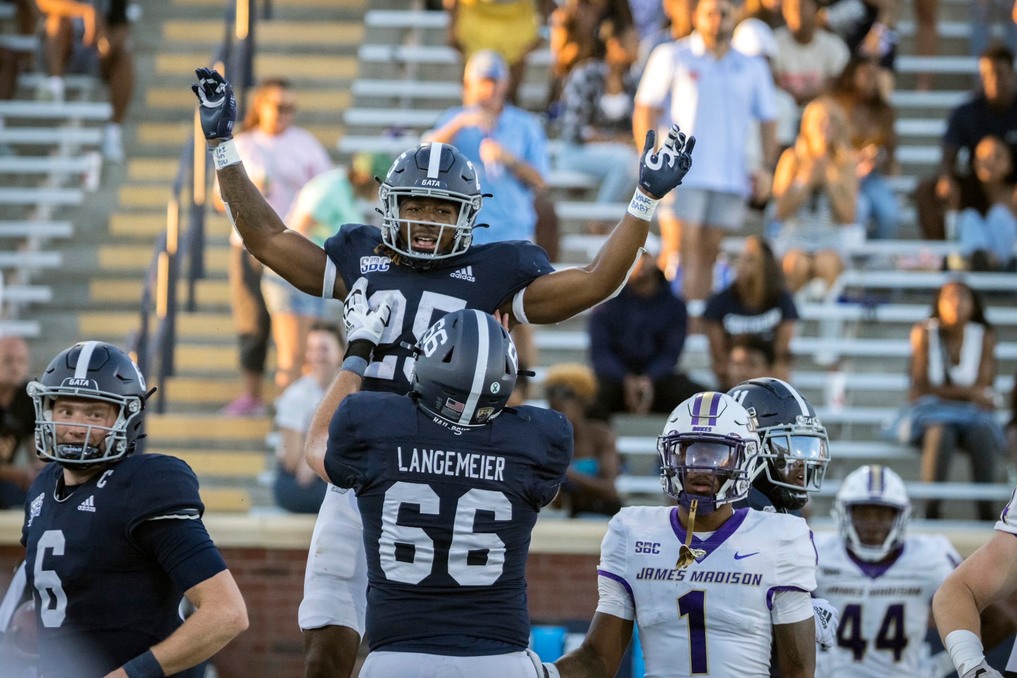 Georgia Southern running back Jalen White (25) celebrates his touchdown with Georgia Southern offensive lineman Logan Langemeier (66) during the second half of an NCAA football game James Madison, Saturday, Oct. 15, 2022, in Statesboro, Ga. (AP Photo/Stephen B. Morton)