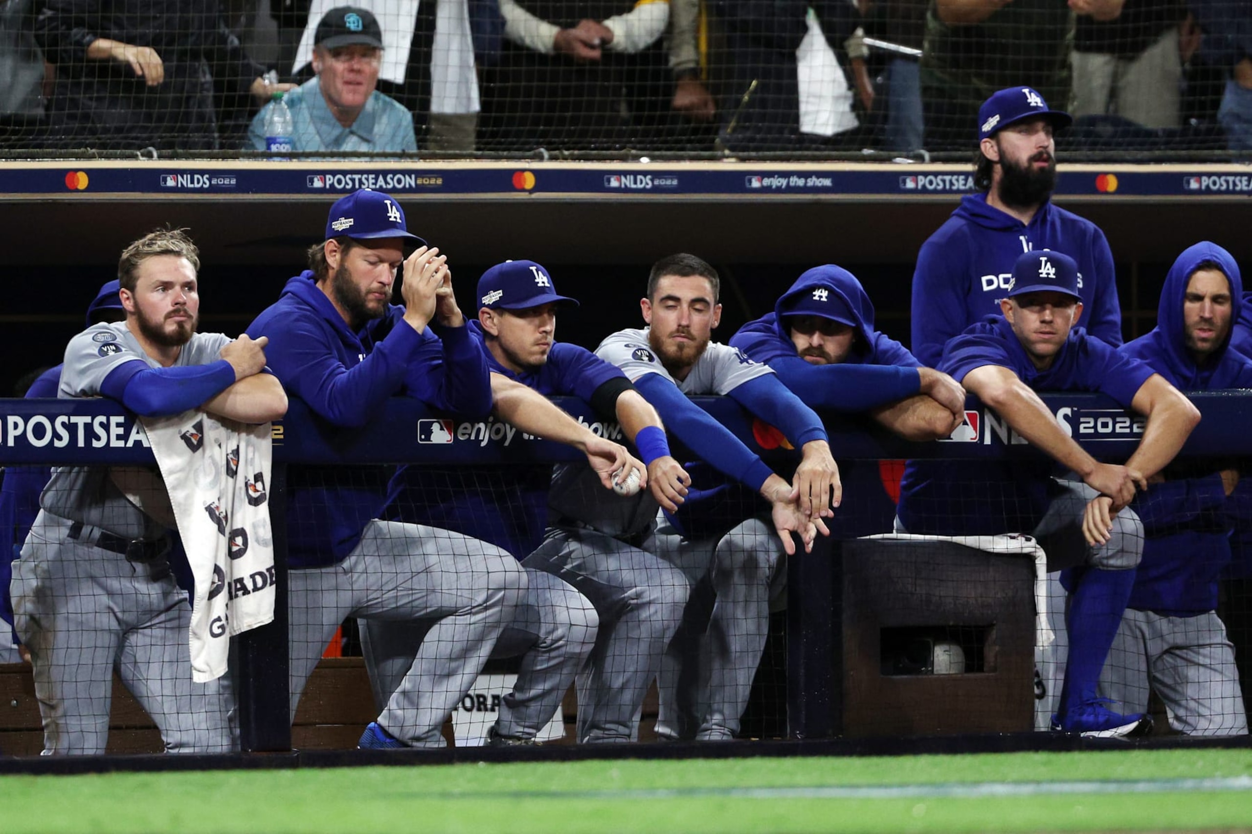 SAN DIEGO, CALIFORNIA - OCTOBER 15: The Los Angeles Dodgers dugout reacts during the ninth inning against the San Diego Padres in game four of the National League Division Series at PETCO Park on October 15, 2022 in San Diego, California. (Photo by Harry How/Getty Images)