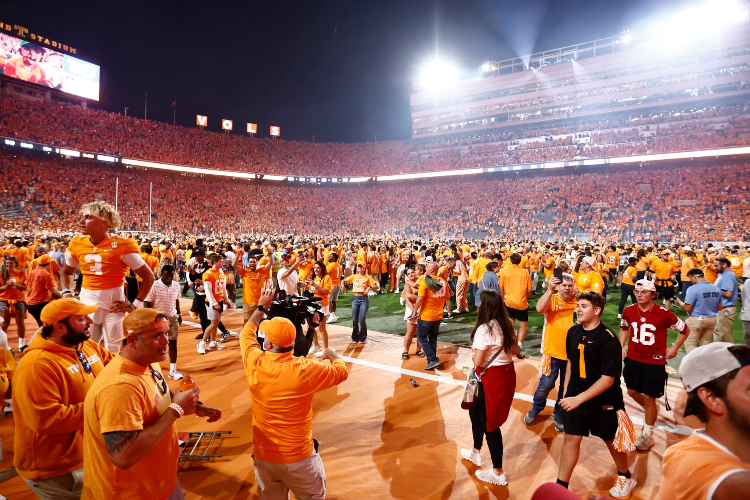 Fans storm the field after an NCAA college football game between Tennessee and Alabama, Saturday, Oct. 15, 2022, in Knoxville, Tenn. Tennessee won 52-49. (AP Photo/Wade Payne)