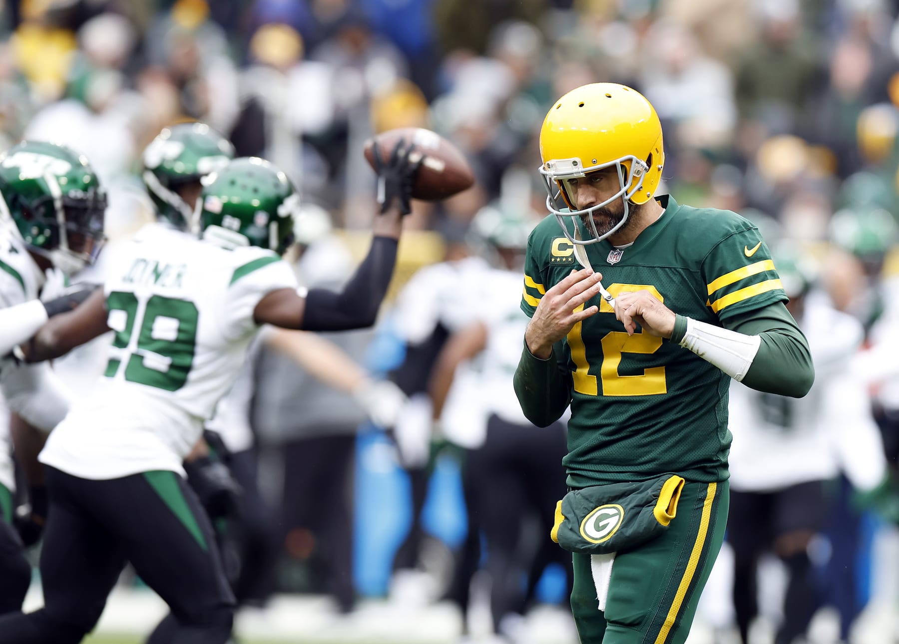GREEN BAY, WISCONSIN - OCTOBER 16: Aaron Rodgers #12 of the Green Bay Packers walks off the field after the New York Jets recovered a fumble in the second quarter of a game at Lambeau Field on October 16, 2022 in Green Bay, Wisconsin. (Photo by John Fisher/Getty Images)