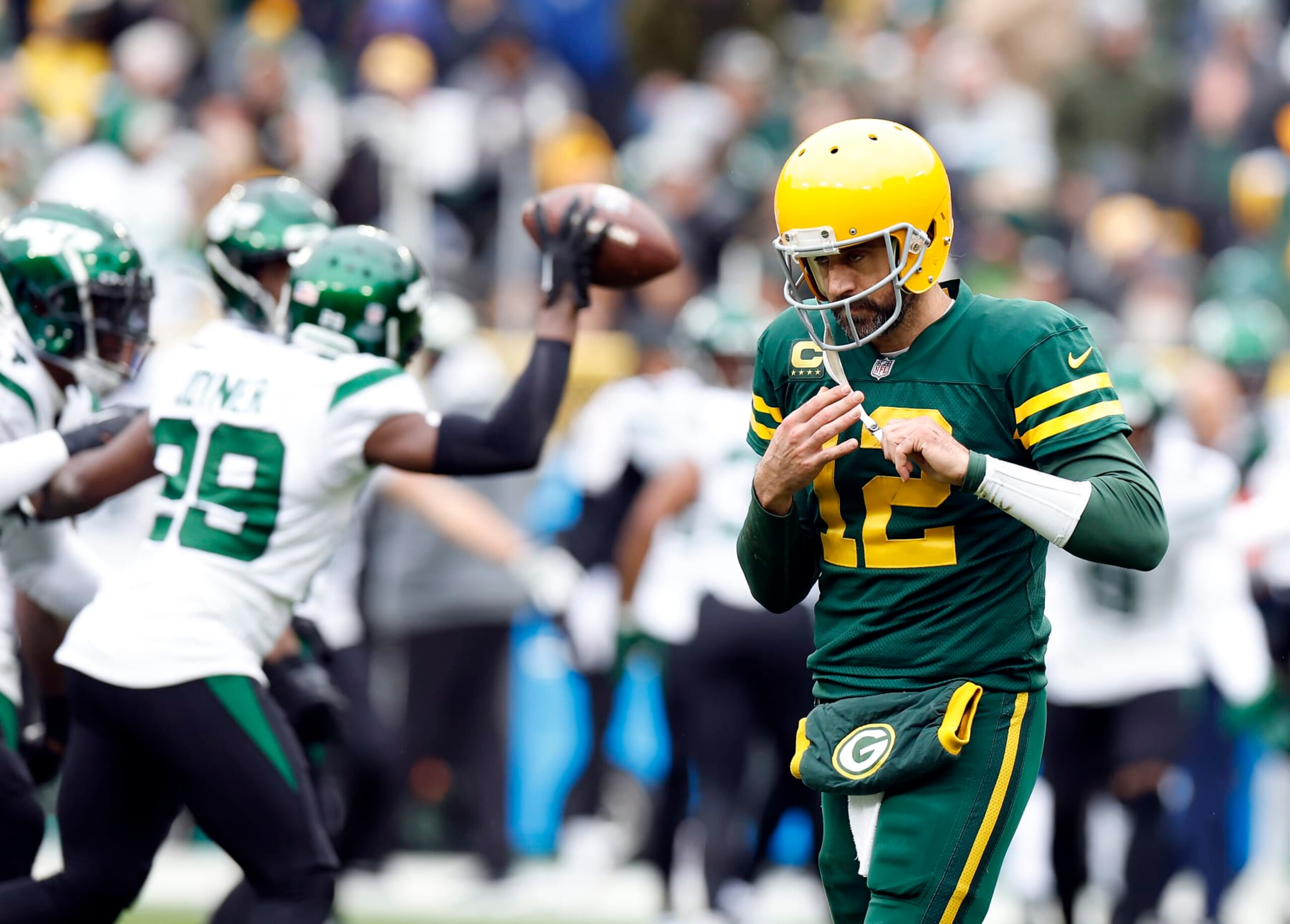 GREEN BAY, WISCONSIN - OCTOBER 16: Aaron Rodgers #12 of the Green Bay Packers walks off the field after the New York Jets recovered a fumble in the second quarter of a game at Lambeau Field on October 16, 2022 in Green Bay, Wisconsin. (Photo by John Fisher/Getty Images)