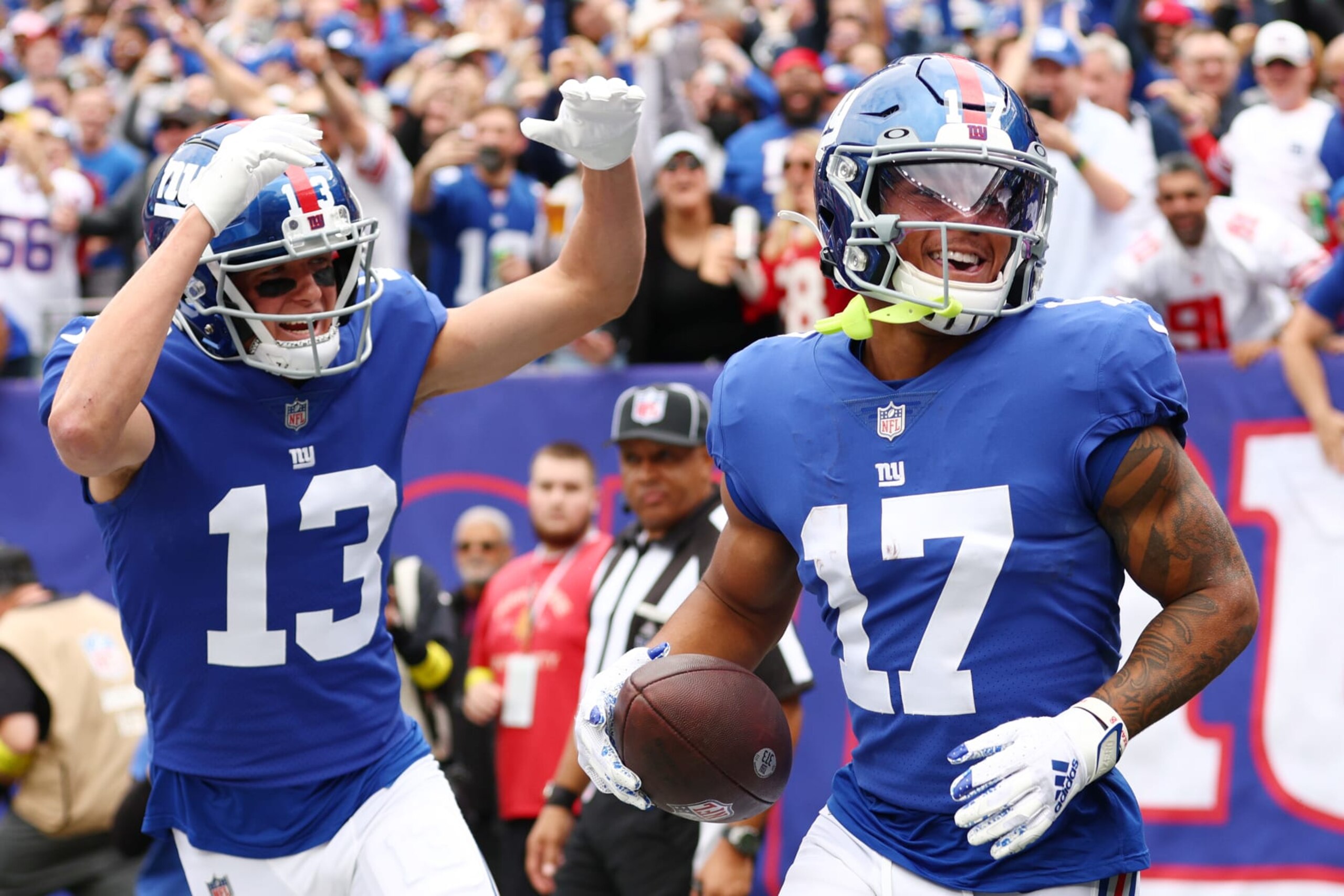 EAST RUTHERFORD, NEW JERSEY - OCTOBER 16: Wan'Dale Robinson #17 of the New York Giants celebrates with David Sills V #13 after scoring a touchdown during the second quarter against the Baltimore Ravens at MetLife Stadium on October 16, 2022 in East Rutherford, New Jersey. (Photo by Elsa/Getty Images)