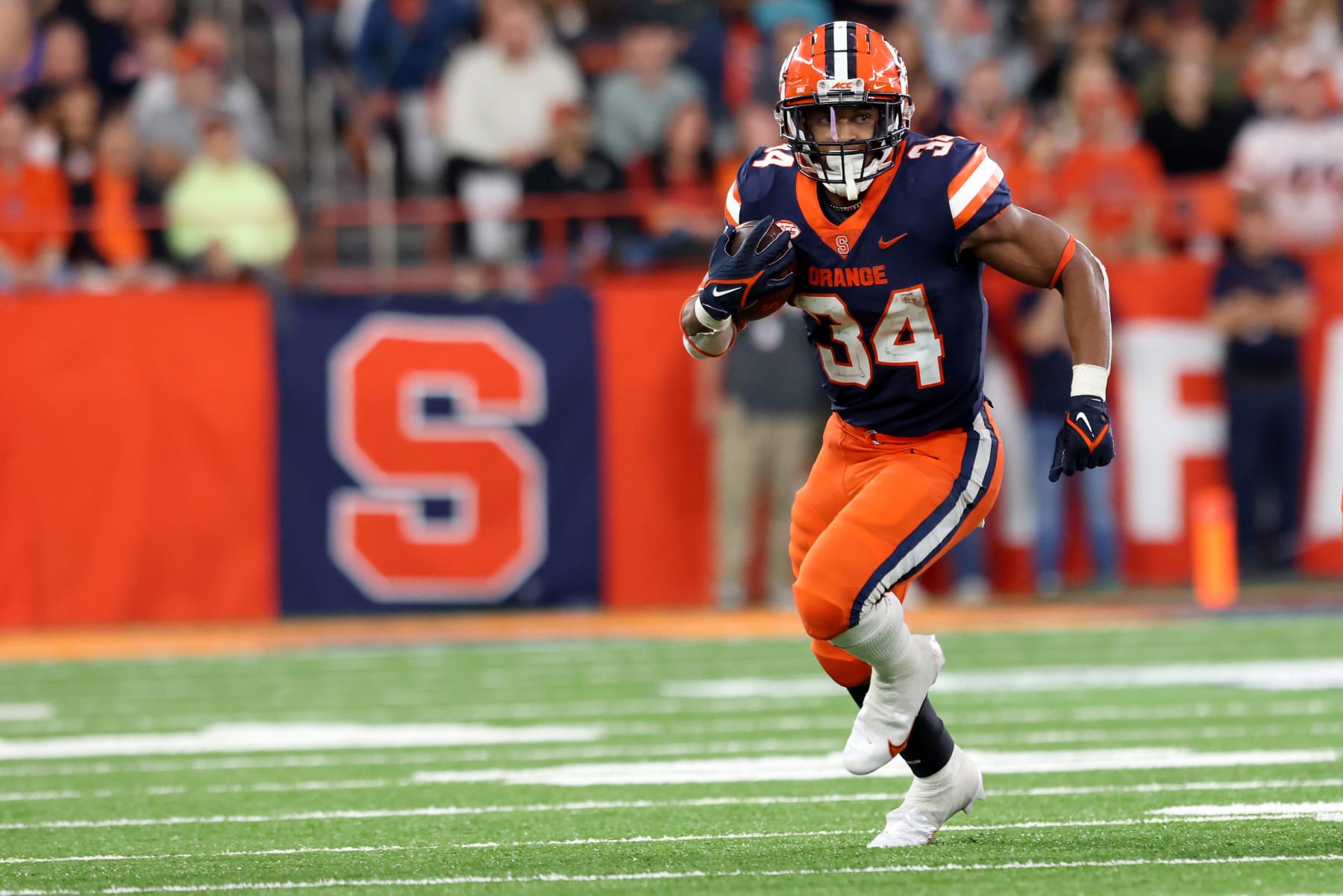 SYRACUSE, NEW YORK - OCTOBER 15: Sean Tucker #34 of the Syracuse Orange runs the ball during the third quarter against the North Carolina State Wolfpack at JMA Wireless Dome on October 15, 2022 in Syracuse, New York. (Photo by Bryan M. Bennett/Getty Images)