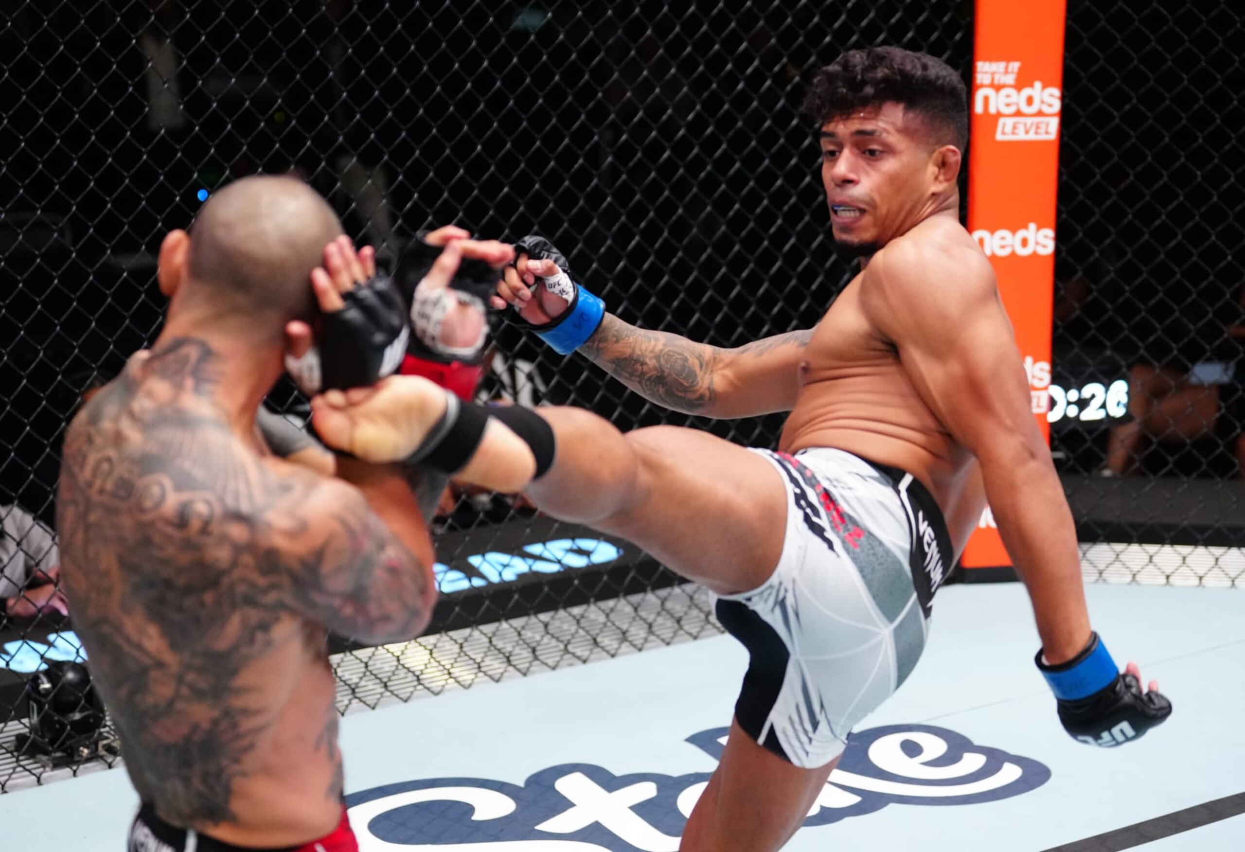 LAS VEGAS, NEVADA - OCTOBER 15: (R-L) Jonathan Martinez kicks Cub Swanson in a bantamweight fight during the UFC Fight Night event at UFC APEX on October 15, 2022 in Las Vegas, Nevada. (Photo by Jeff Bottari/Zuffa LLC)