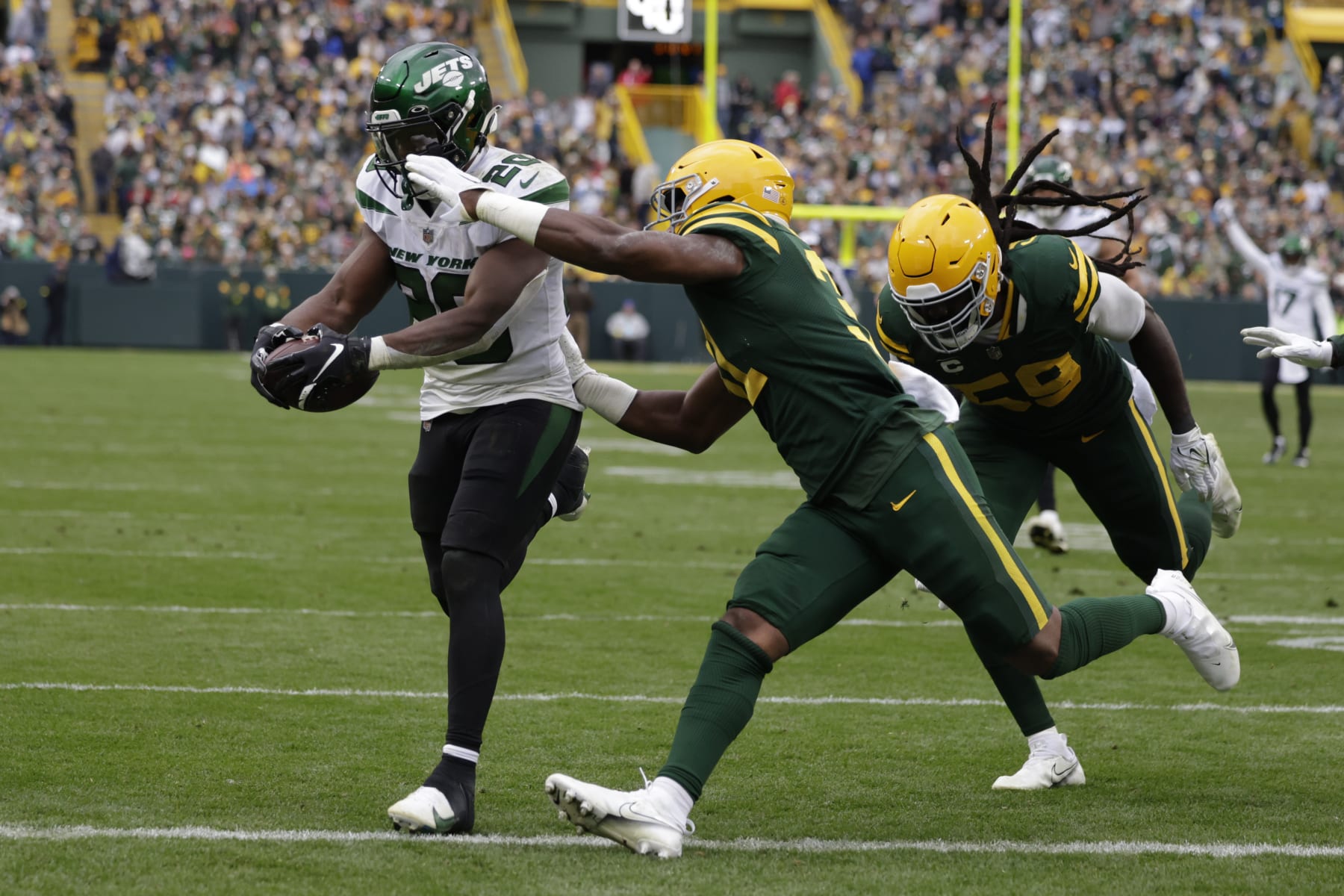 New York Jets running back Breece Hall (20), defended by Green Bay Packers safety Adrian Amos rushes for a 34-yard touchdown during the second half of an NFL football game Sunday, Oct. 16, 2022, in Green Bay, Wis. (AP Photo/Matt Ludtke)