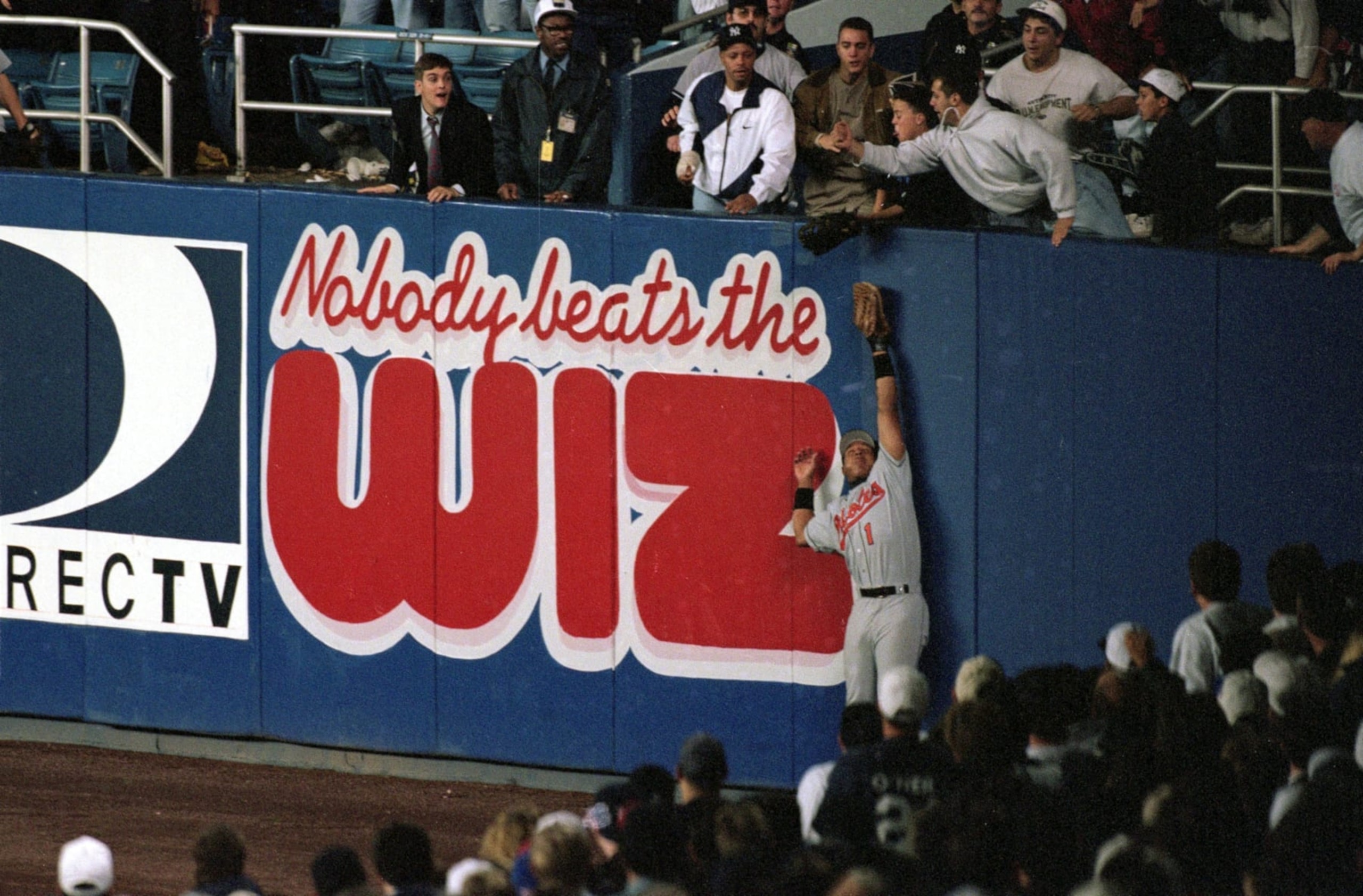 Baseball: ALCS Playoffs: Baltimore Orioles Tony Tarasco (1) in action, tracking ball as fan Jeffrey Maier reaches from stands and catches home run ball hit by Derek Jeter at Yankee Stadium. Game 1. 
Bronx, NY 10/9/1996
CREDIT: Al Tielemans (Photo by Al Tielemans /Sports Illustrated via Getty Images)
(Set Number: X51515 TK1 R2 F8 )